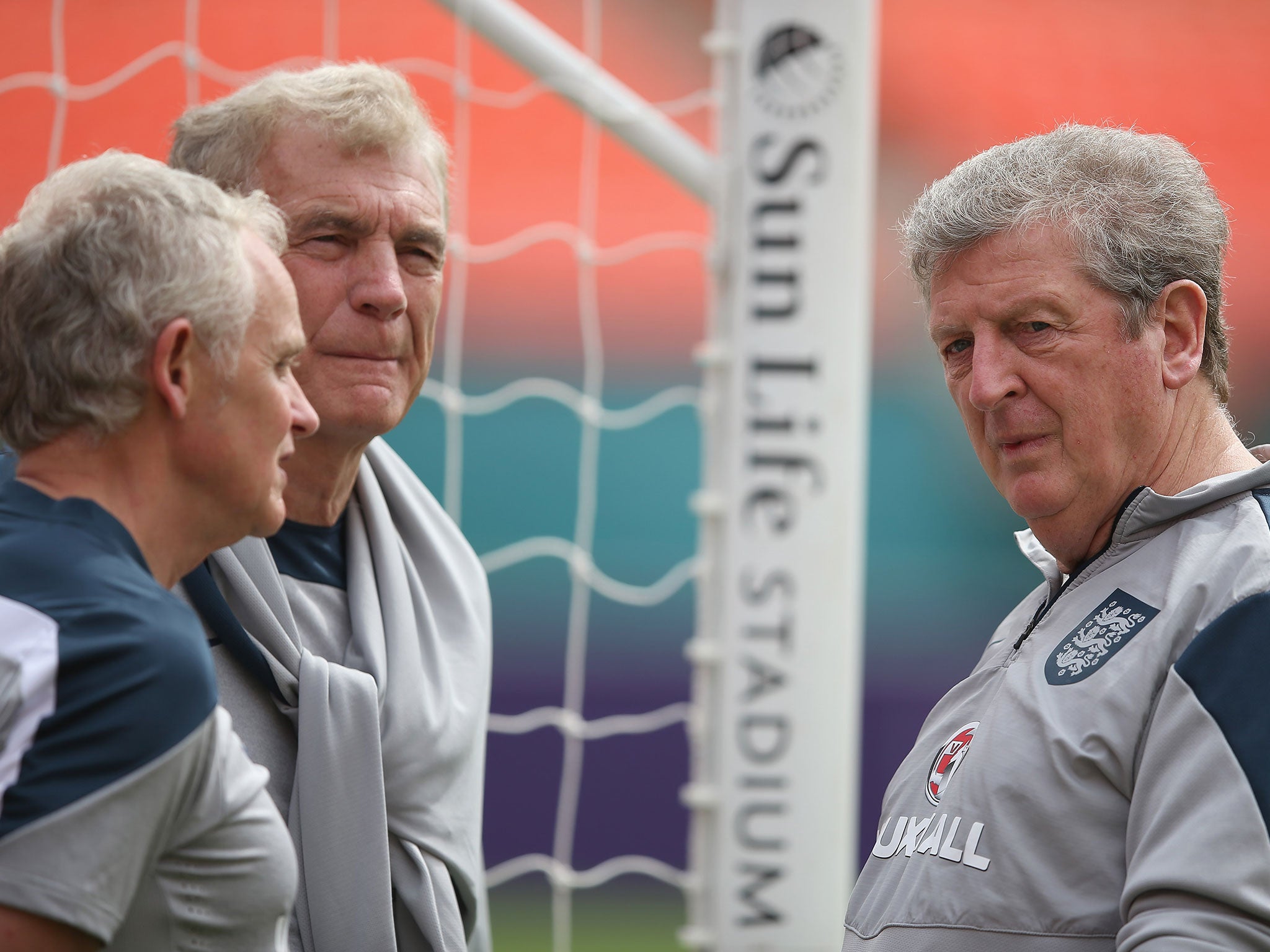 Roy Hodgson talks with Sir Trevor Brooking and Dr Steve Peters (L) during an England training session at The Sunlife Stadium