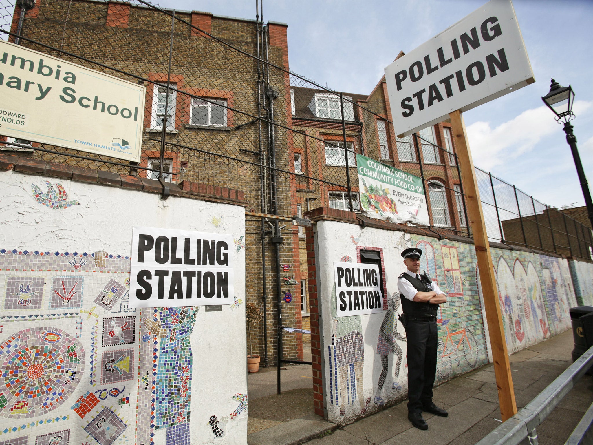 A police officer outside a polling station in Tower Hamlets, east London