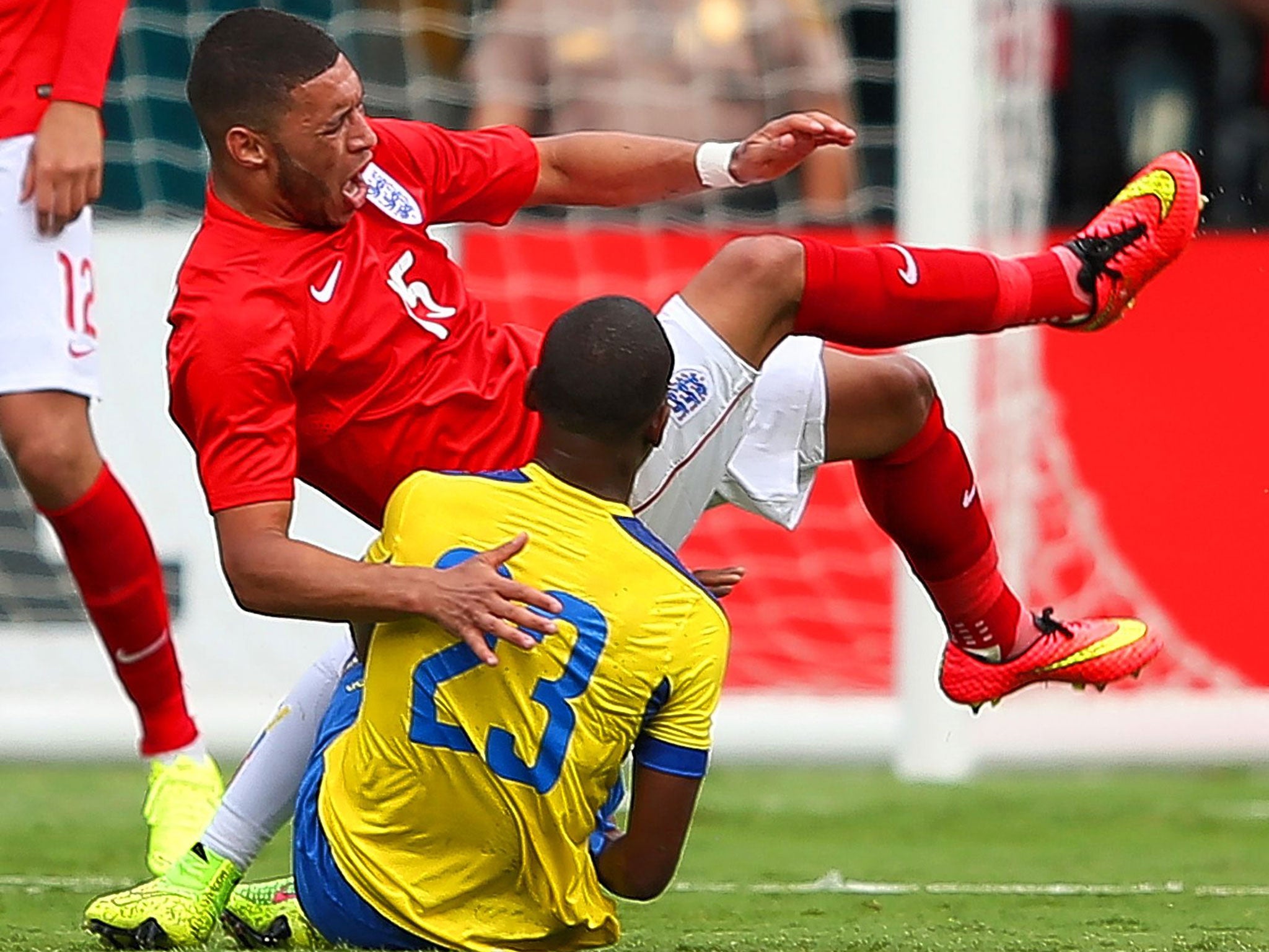 Alex Oxlade-Chamberlain goes down in pain under a challenge from Carlos Gruezo at the Sun Life Stadium in Miami