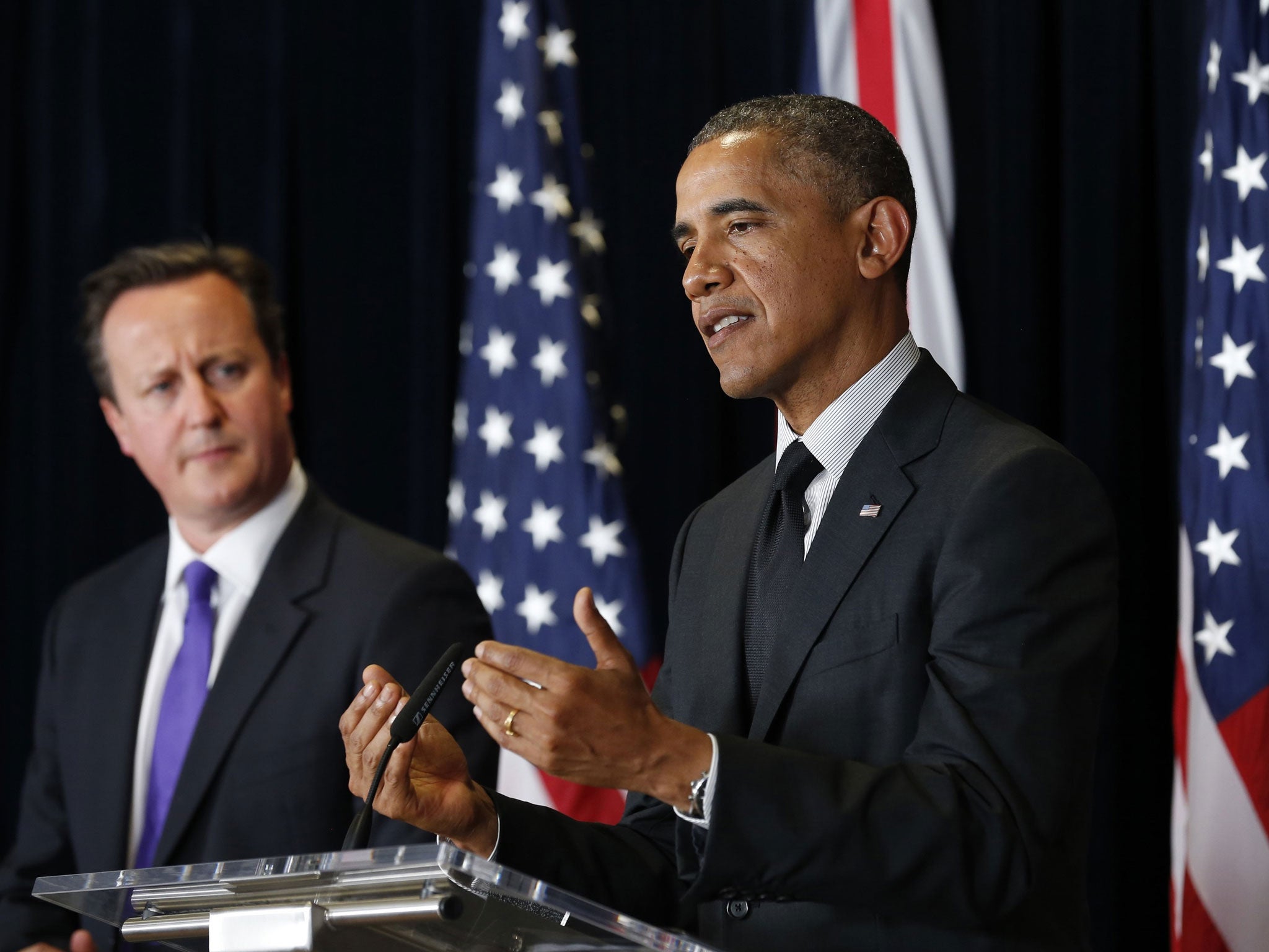 US President Barack Obama speaks next to David Cameron at a joint news conference after their meeting at the G7 summit in Brussels