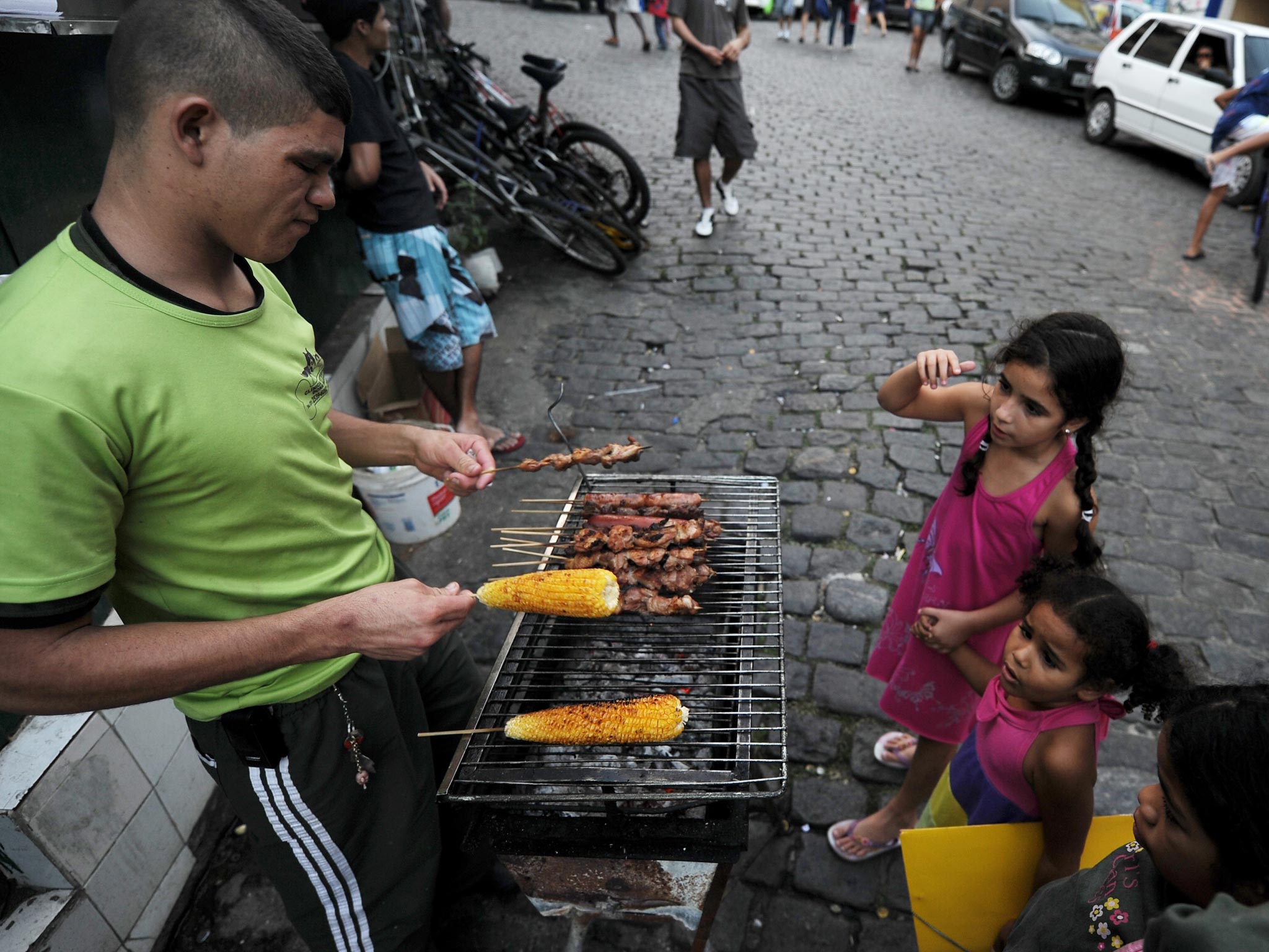 A bite of the action: A peddler sells snacks at one of the entrances to the Santa Marta ‘favela’ (shantytown) in Rio de Janeiro, Brazil