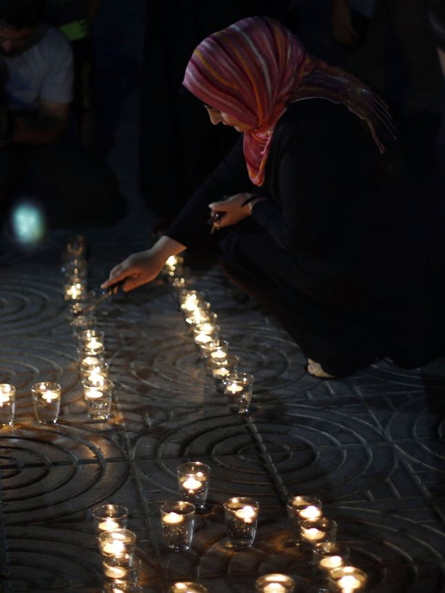 A Palestinian lights candles during a protest in solidarity with prisoners on hunger strike in Gaza City on 5 June, 2014.