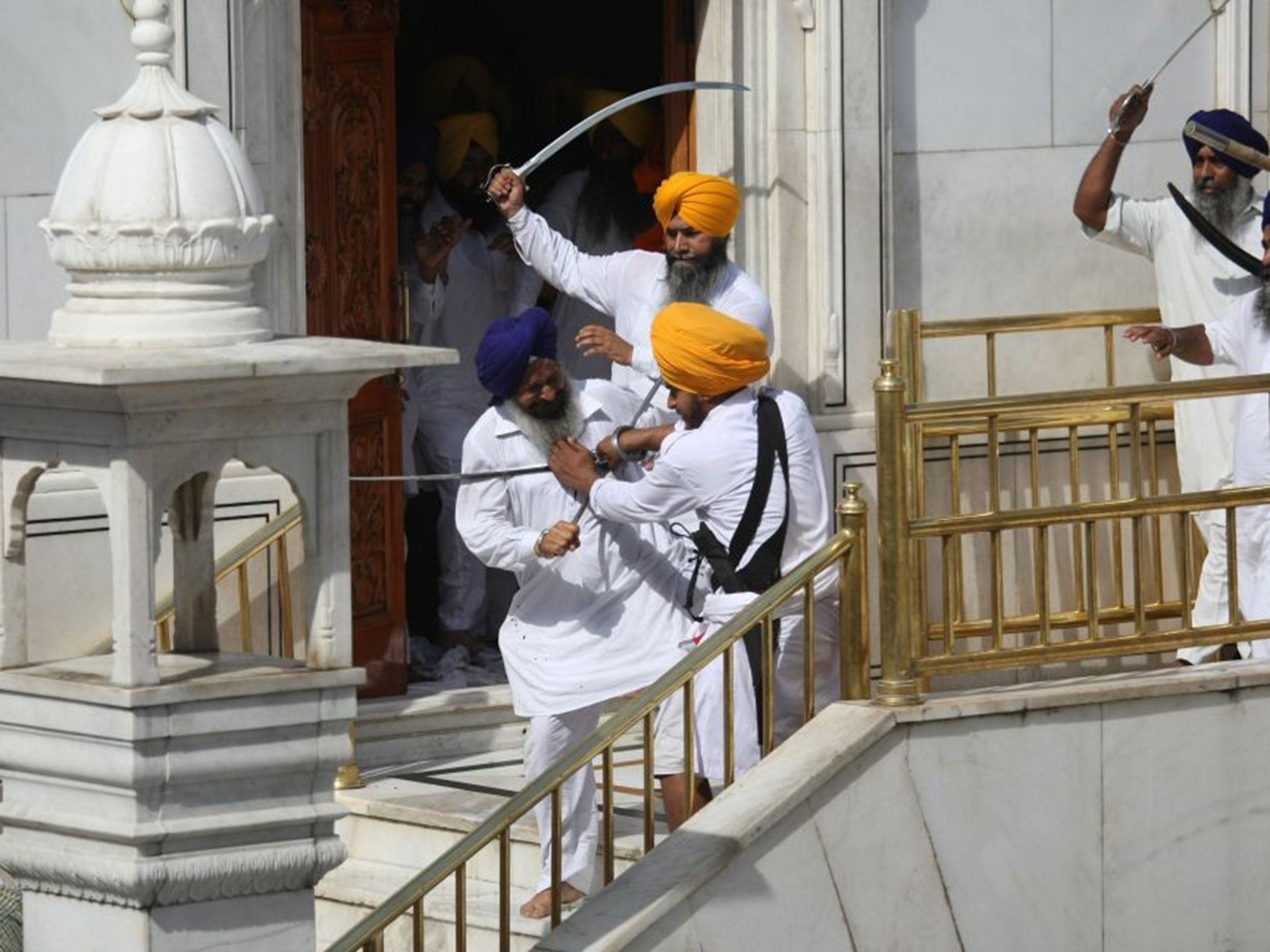 Rival Sikh groups clash outside the Golden Temple at Amritsar
