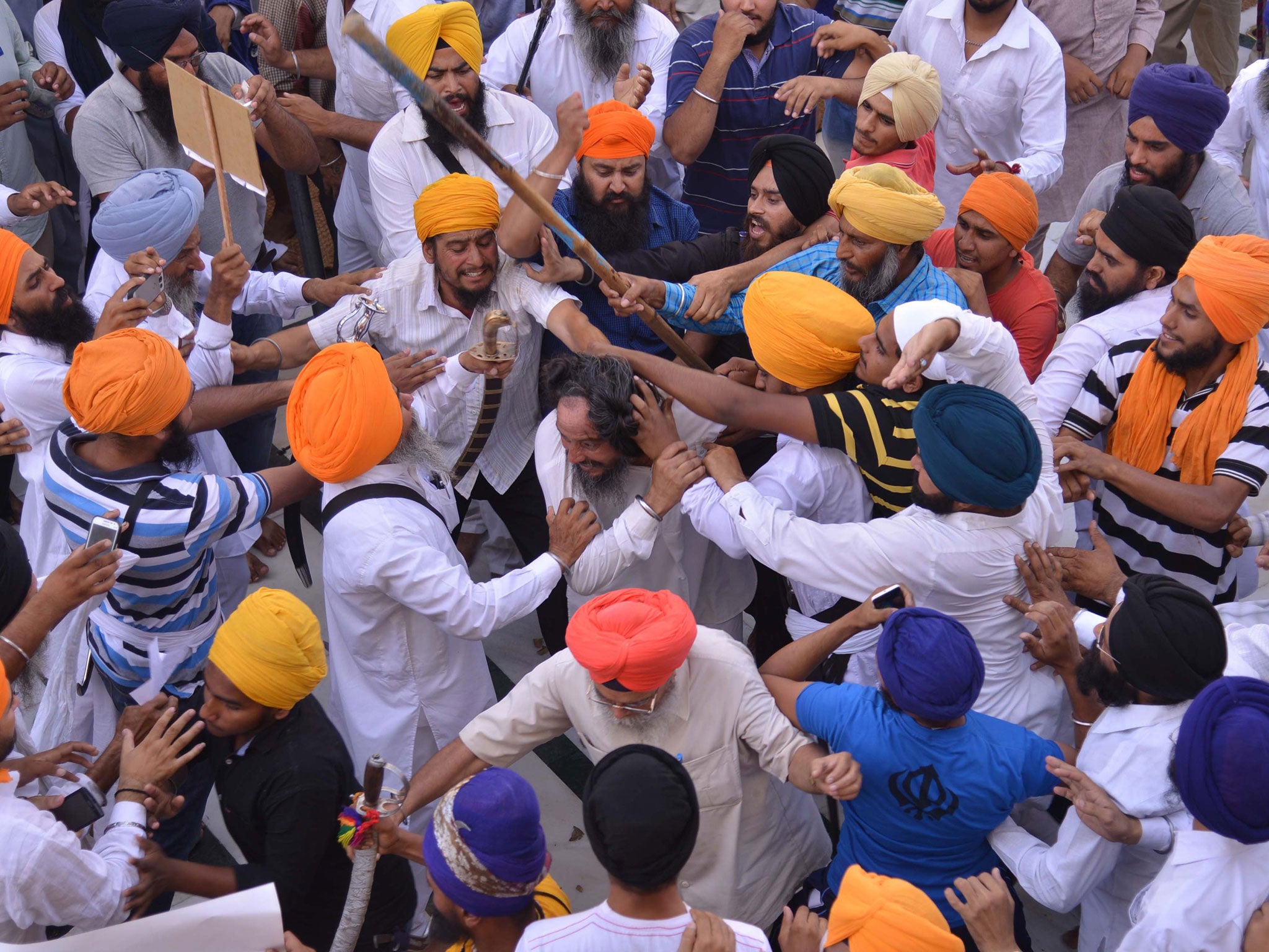Clashes broke out between sword-wielding Sikhs at the Golden Temple in northern India on the 30th anniversary of a notorious army raid on the site. At least 12 people were wounded in the violence at the temple in the city of Amritsar, which is the holiest