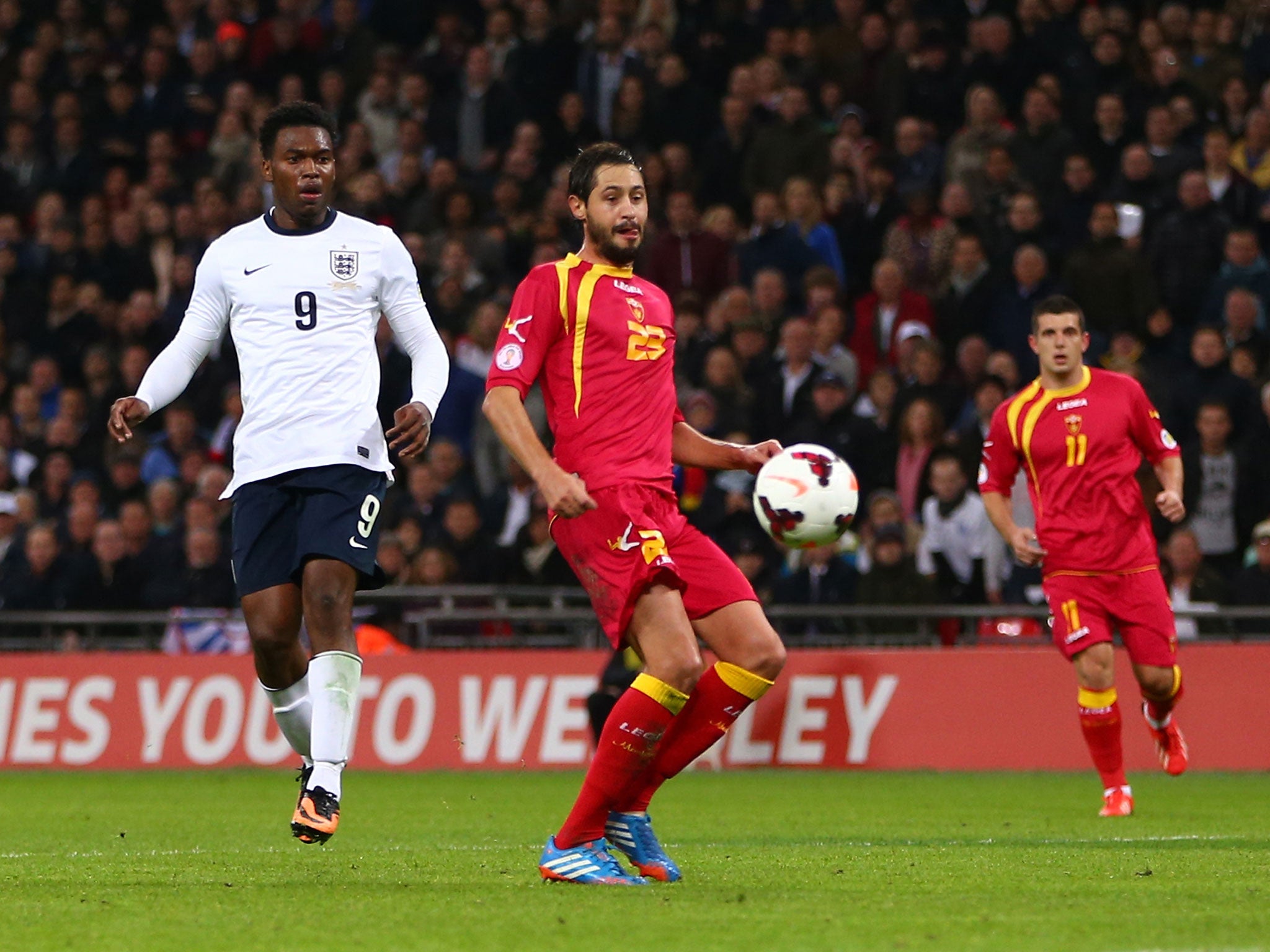 Daniel Sturridge looks on as Branko Boskovic of Montenegro scores an own goal during the FIFA 2014 World Cup Qualifying Group H match between England and Montenegro at Wembley Stadium on October 11, 2013 in London, England.