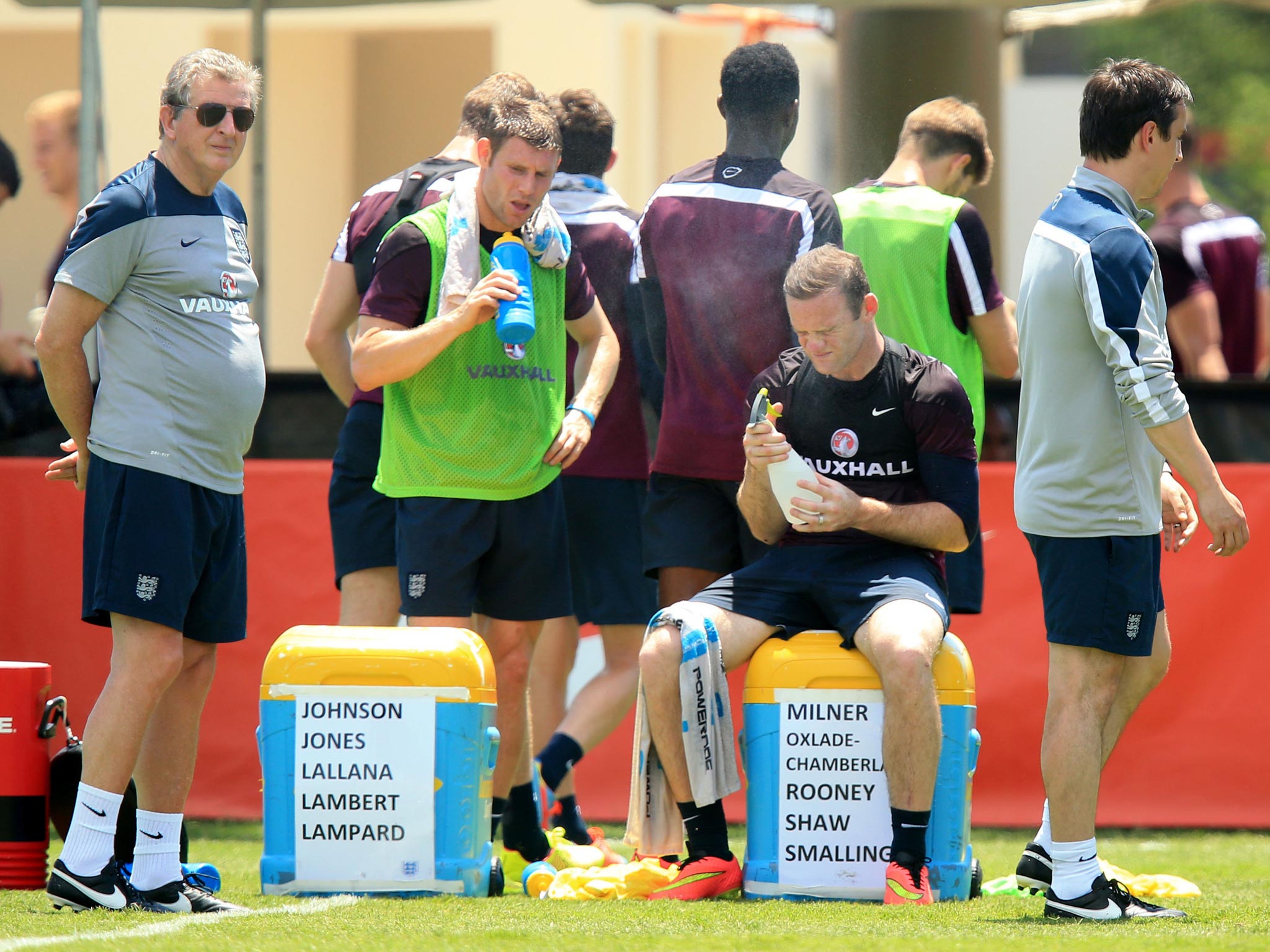 Wayne Rooney (right) and James Milner feel the heat as Roy Hodgson looks on during England training yesterday