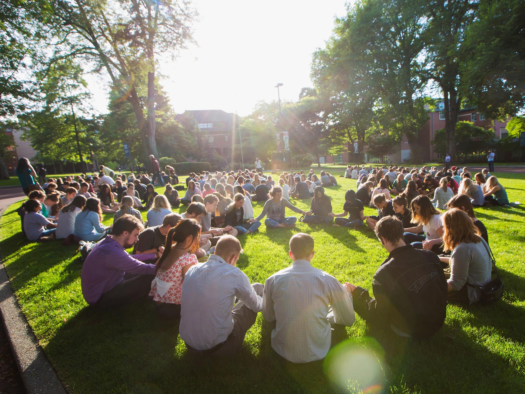 Students link hands and pray on the campus lawns of Seattle Pacific University,
where Thursday’s fatal shooting took place