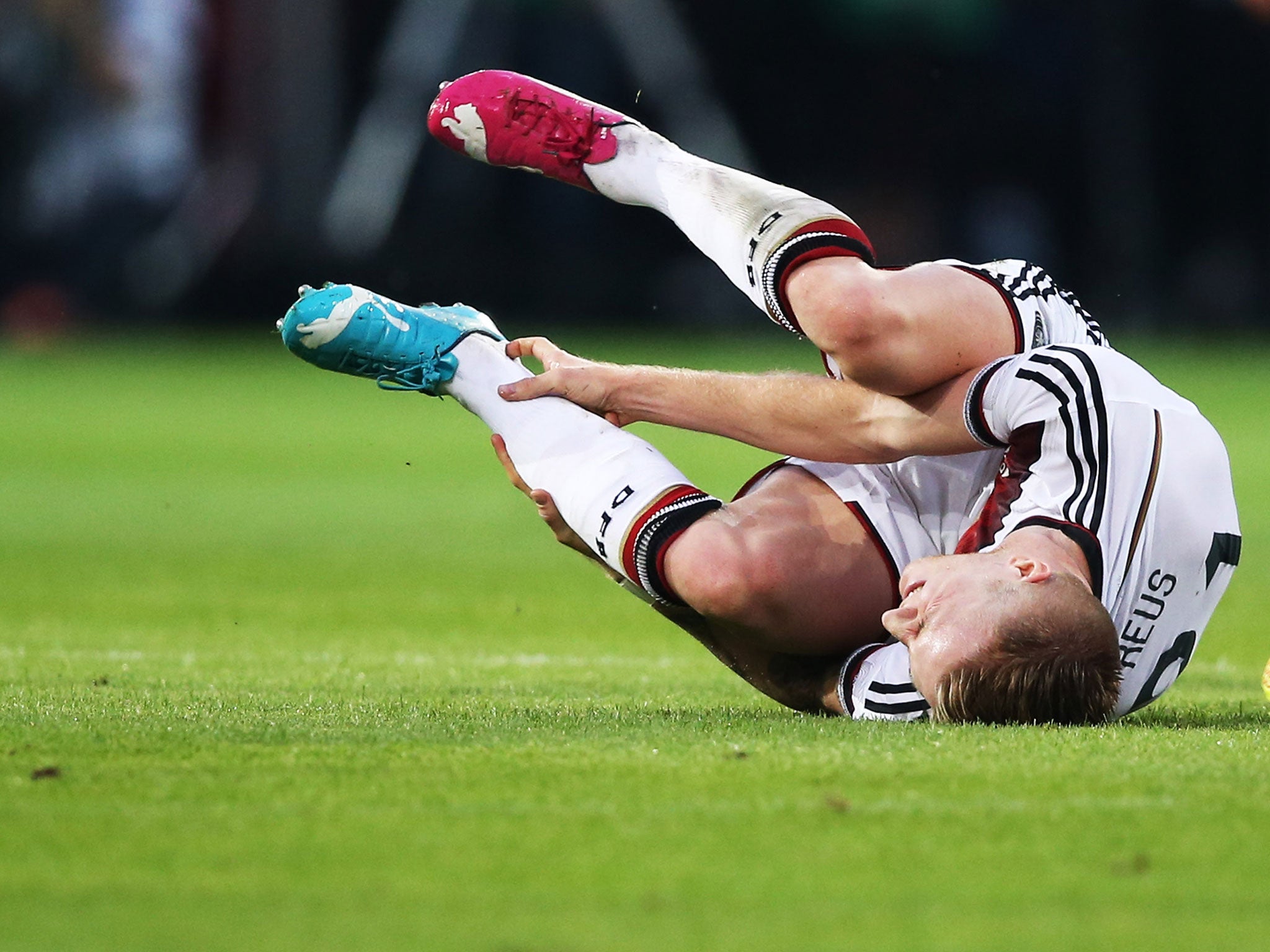 Reus goes down injured after suffering a partial tear of an ankle ligament