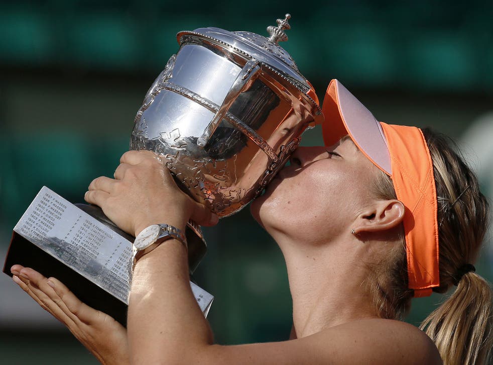 Russia's Maria Sharapova kisses the Suzanne Lenglen trophy after winning her French tennis Open final match against Romania's Simona Halep at the Roland Garros stadium