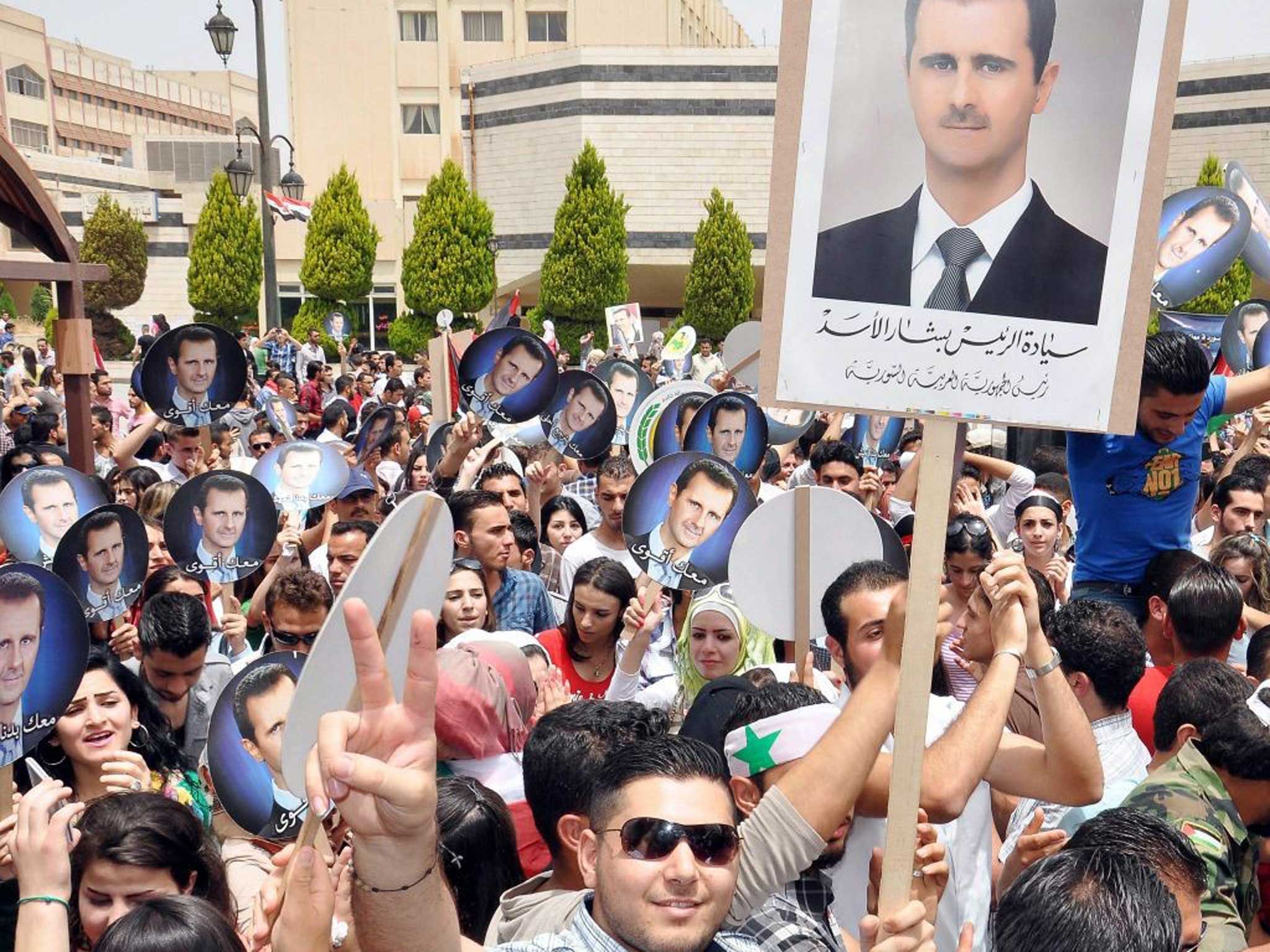 Zero tolerance: Bashar al-Assad supporters turn out to mark his election to a third seven-year term as president