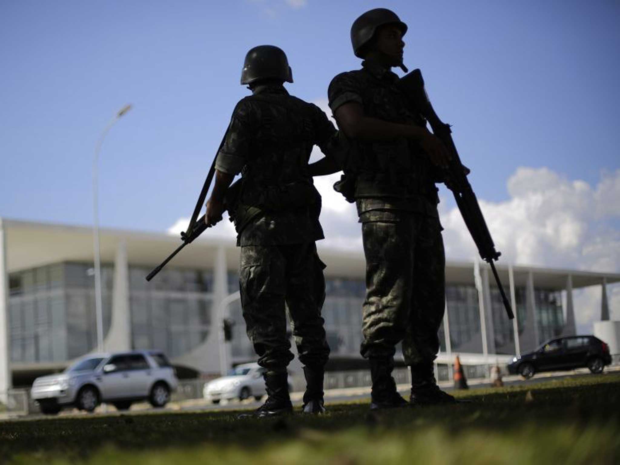 Brazilian army soldiers stand during a security plan drill