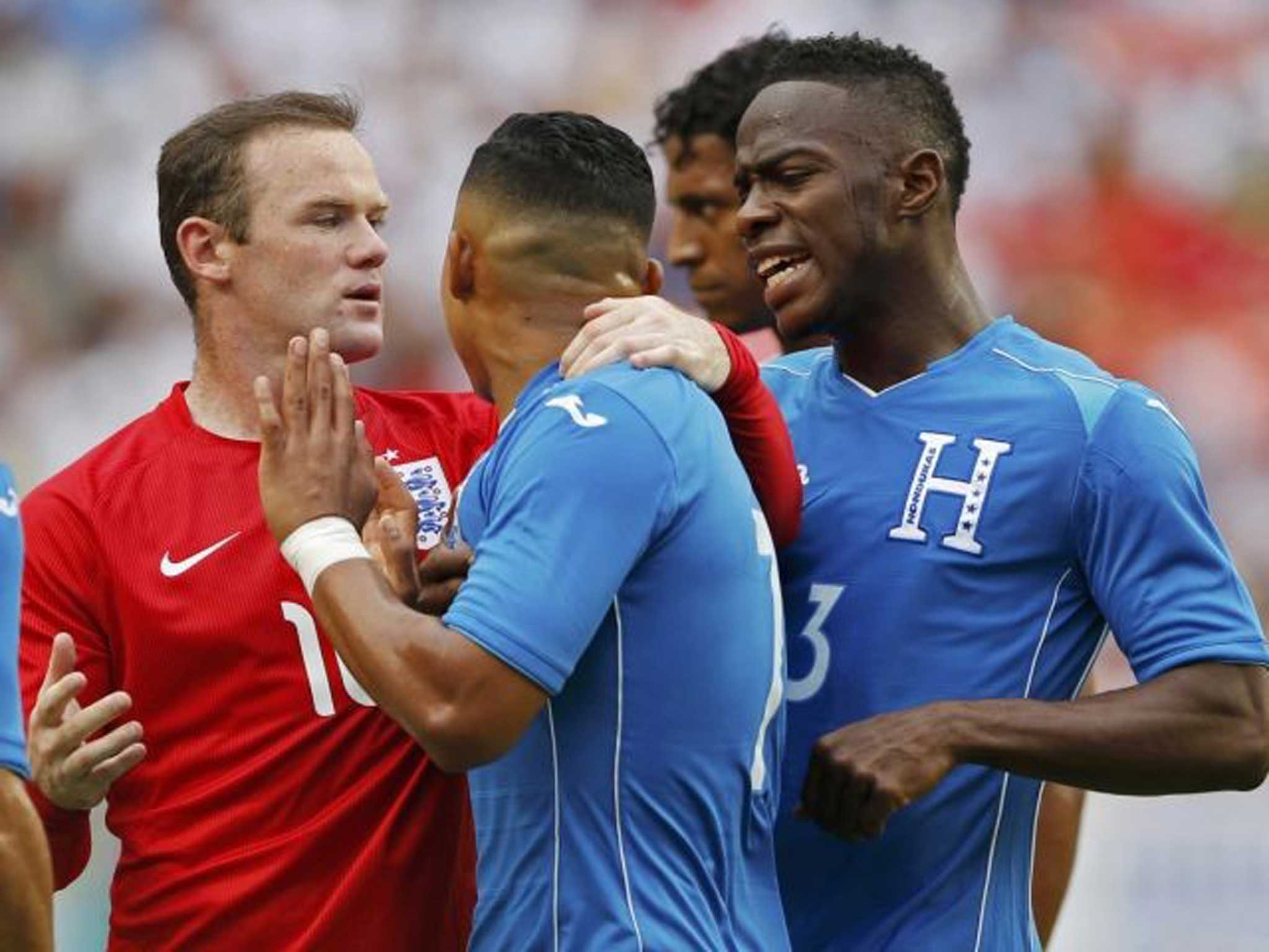 Rooney gets to grips with Emilio Ezaguirre after he kicks the ball at Daniel Sturridge