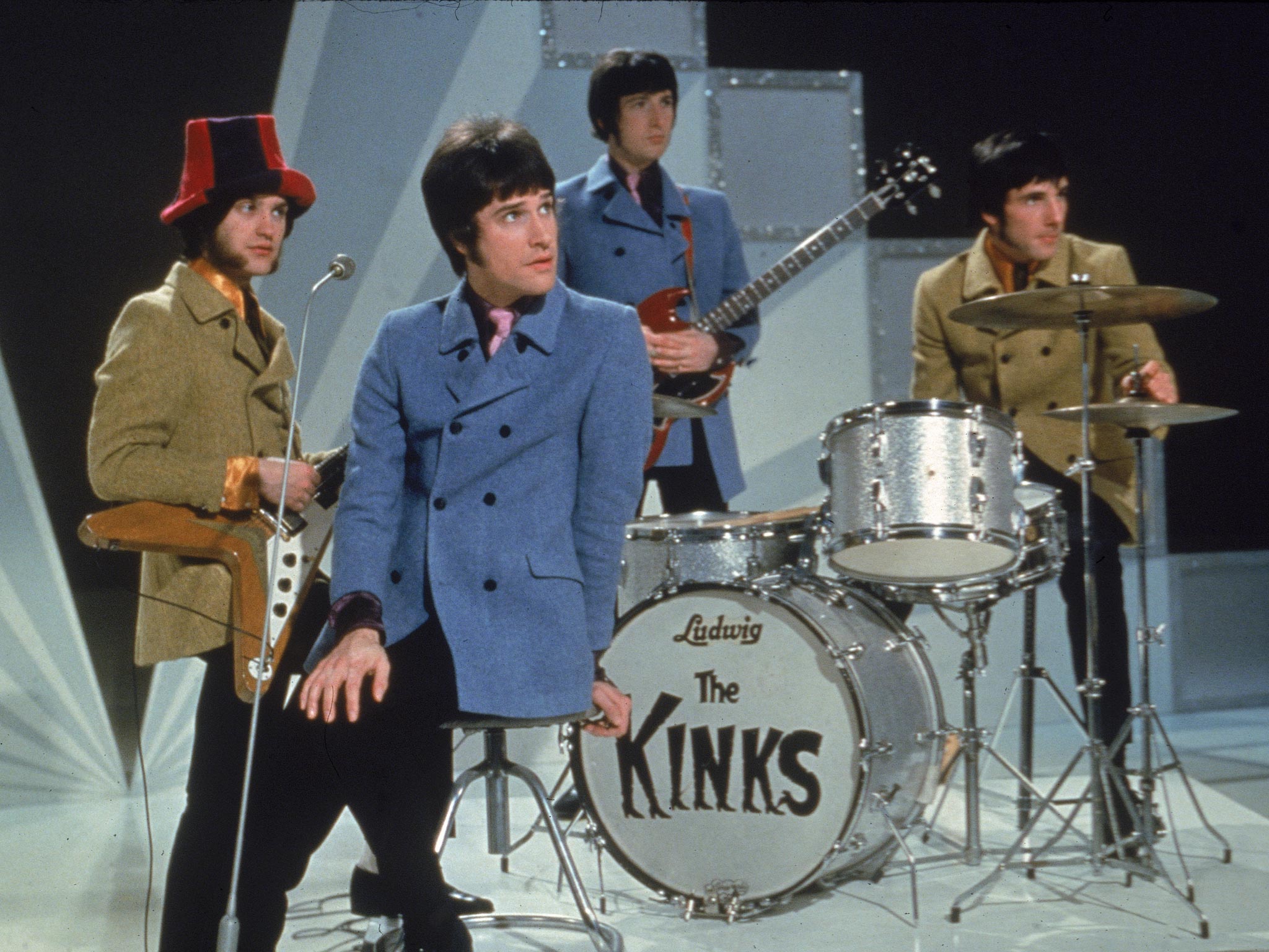 From left to right: Ray Davies, Peter Quaife, and Mick Avory, wait on the set of a television show getting ready to perform in 1968