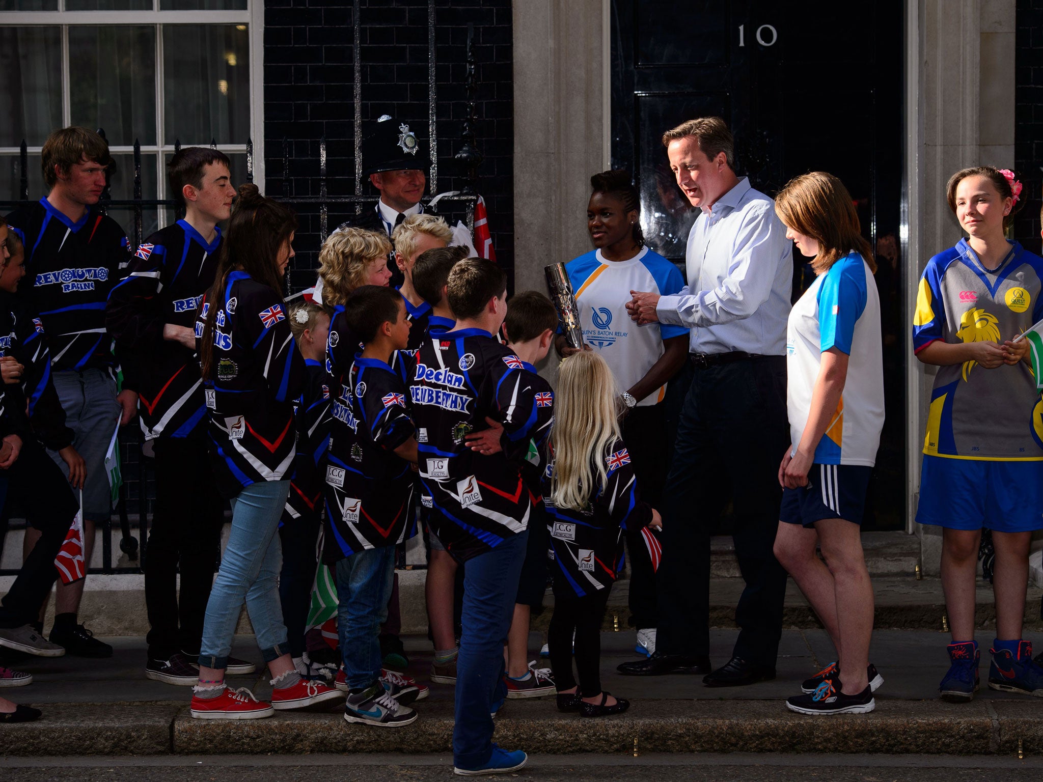David Cameron greets children carrying the Glasgow 2014 Queen’s Baton as the relay arrives at Number 10