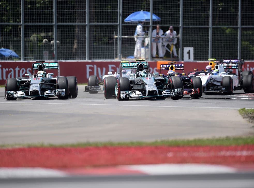 Lewis Hamilton (L) and Nico Rosberg (R) dice for the lead going into the first corner of the Canadian Grand Prix