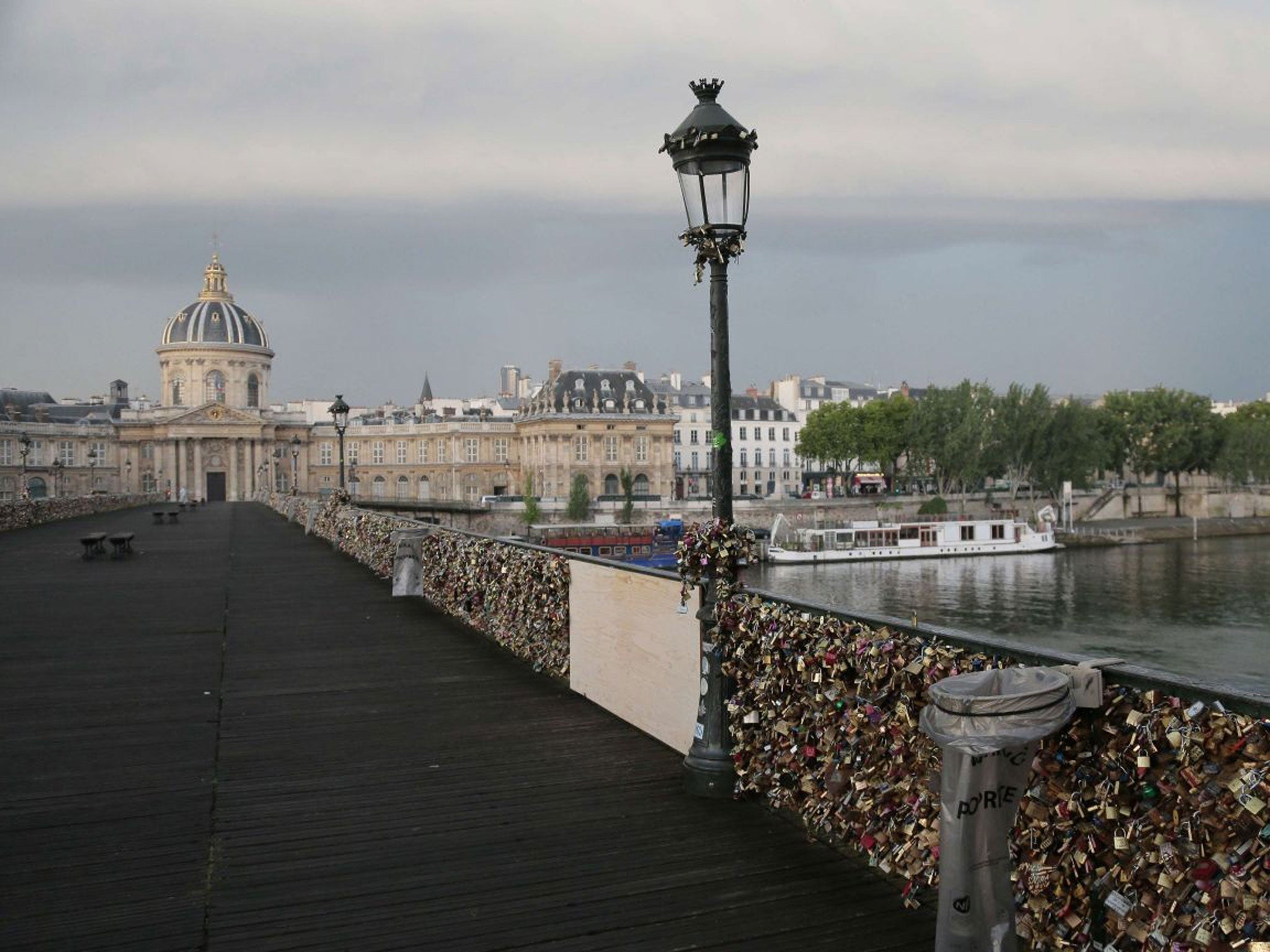 A photo taken on June 9, 2014 shows 'love padlocks' attached to a fence of the Pont des Arts bridge over the Seine river in Paris