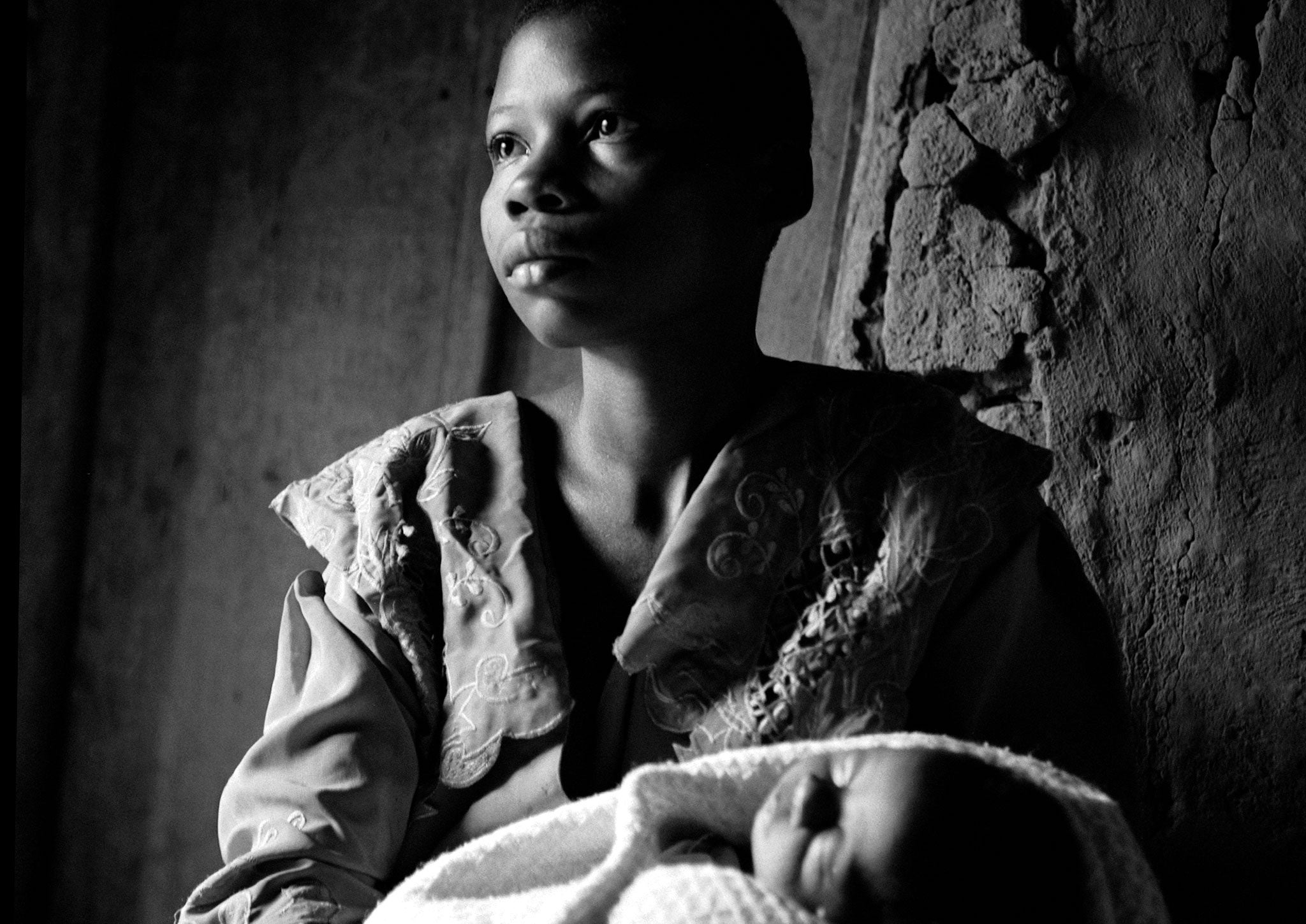 19 year-old Brigitte with her baby boy Damas, conceived when she was raped. Damas died shortly after this was taken. Photograph by Fiona Lloyd-Davies