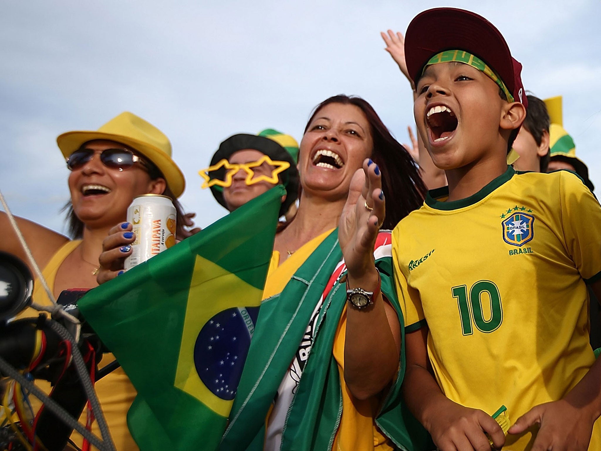Brazil fans cheer while gathered outside Itaquerao stadium, also known as Arena de Sao Paulo and Arena Corinthians in Sao Paulo