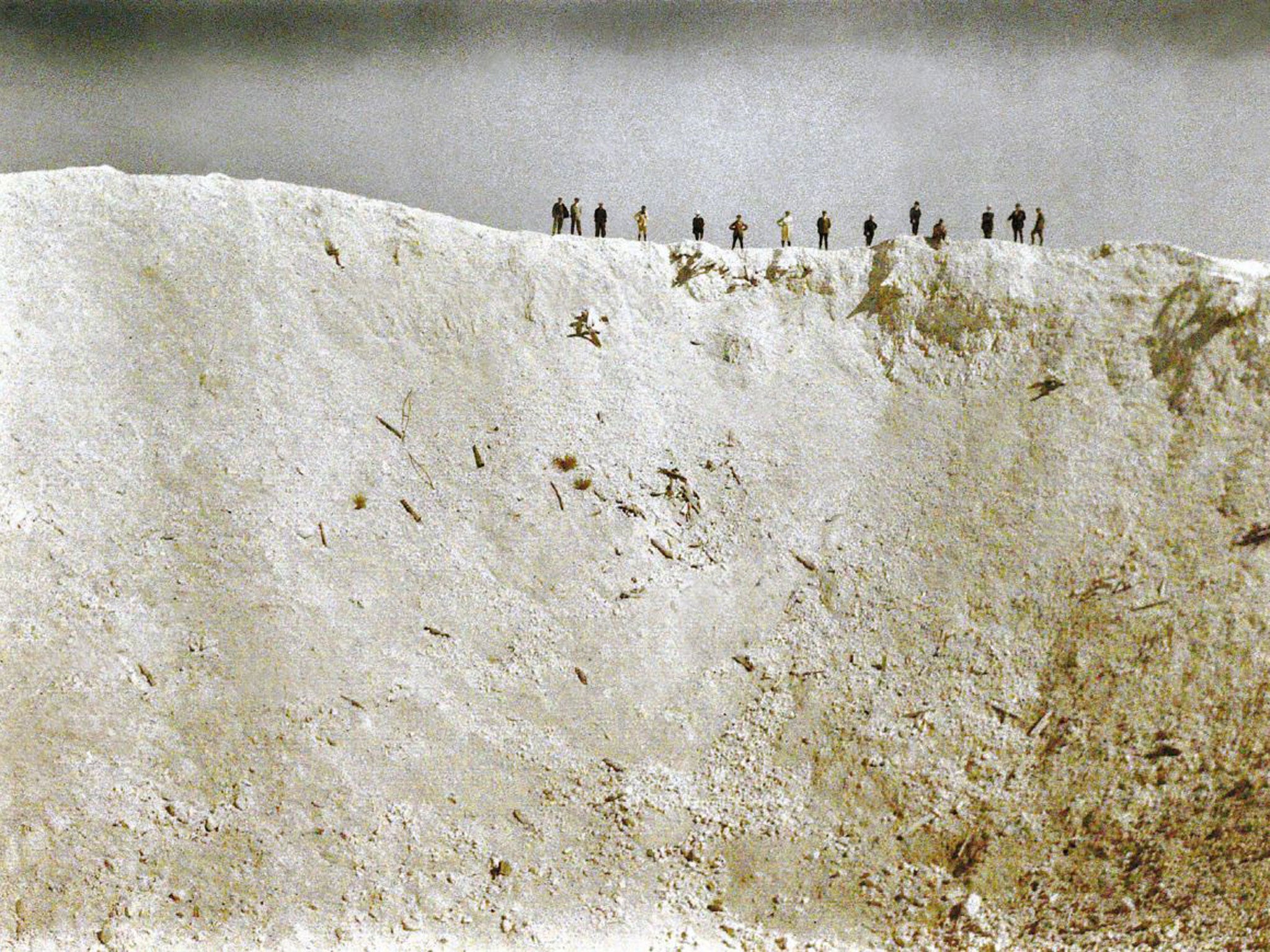 An early colour photograph of the crater left by the biggest of the blasts beneath German positions near Messines on 14 June 1917