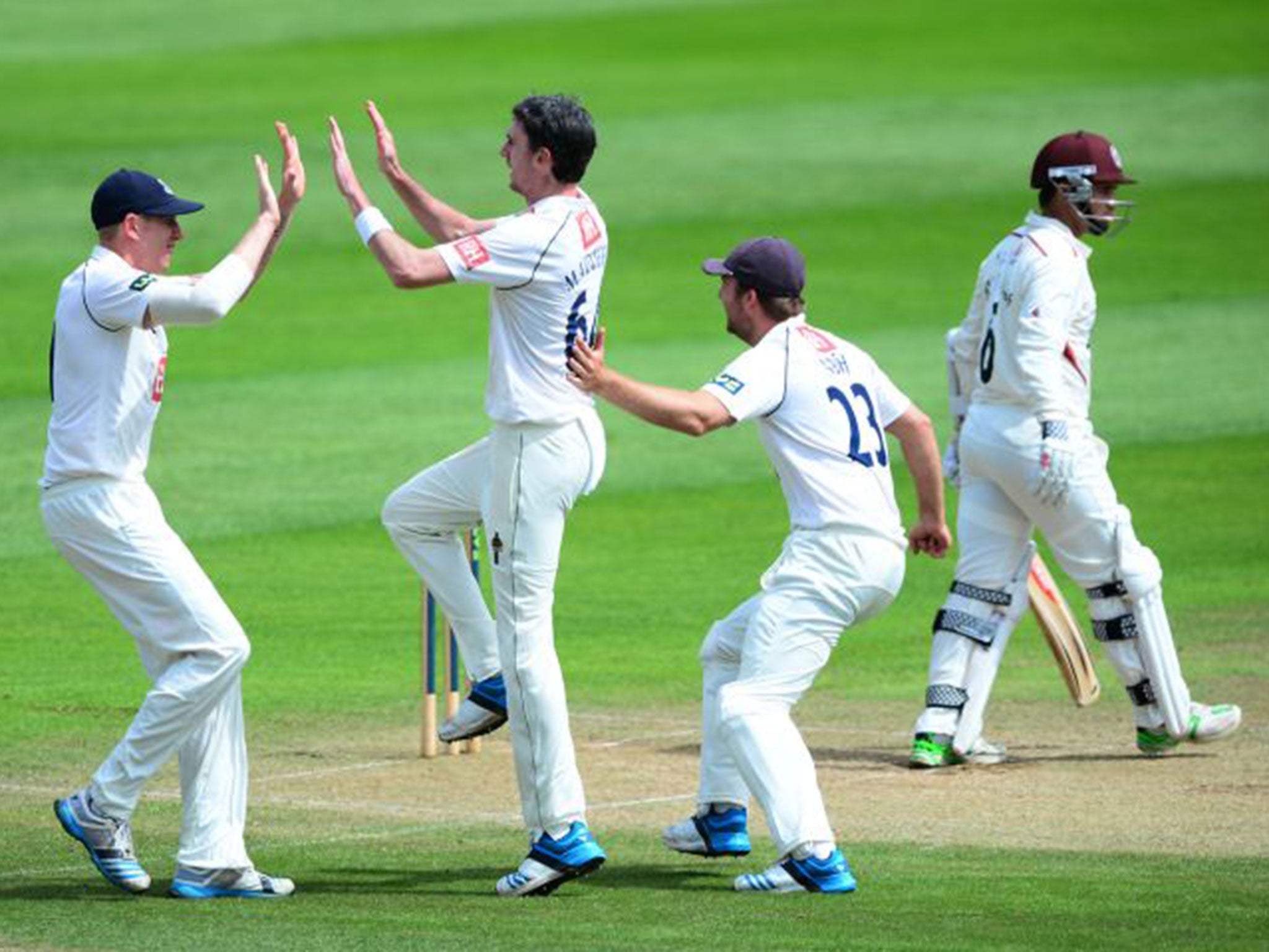 Steve Magoffin (second left), of Somerset, celebrates taking the wicket of Somerset’s Johann Myburg