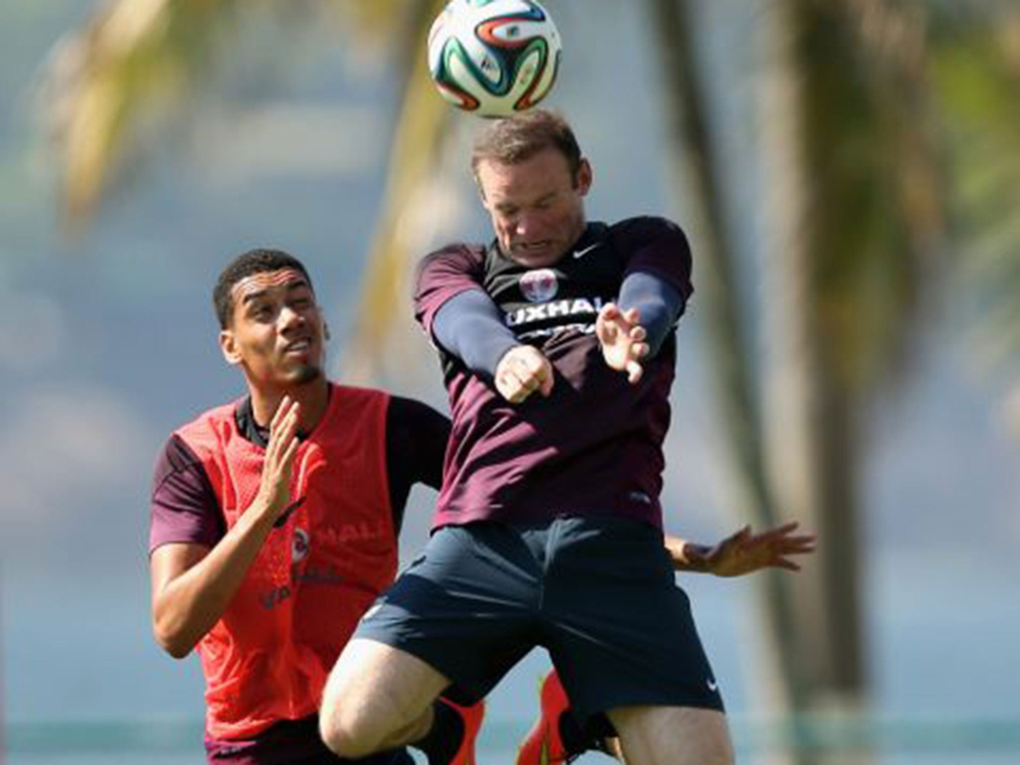 Wayne Rooney outjumps Chris Smalling during England training in Rio