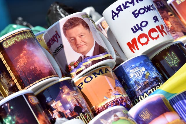 A mug with Poroshenko's face on it marks the new Ukranian president's inauguration