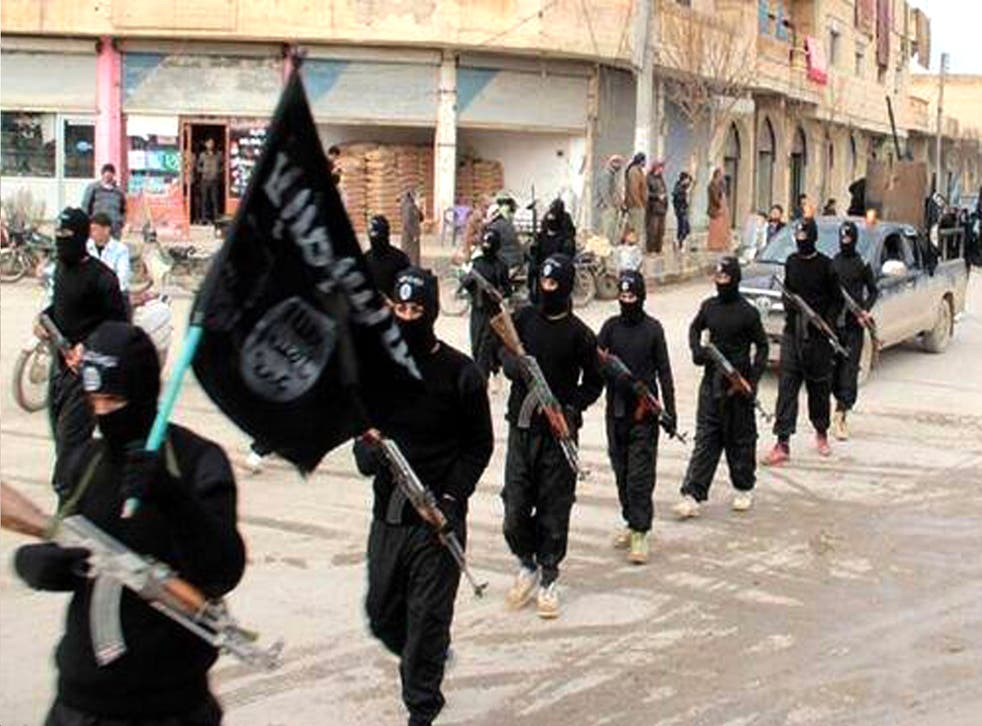 Fighters from ISIS marching in Raqqa, Syria (AP)