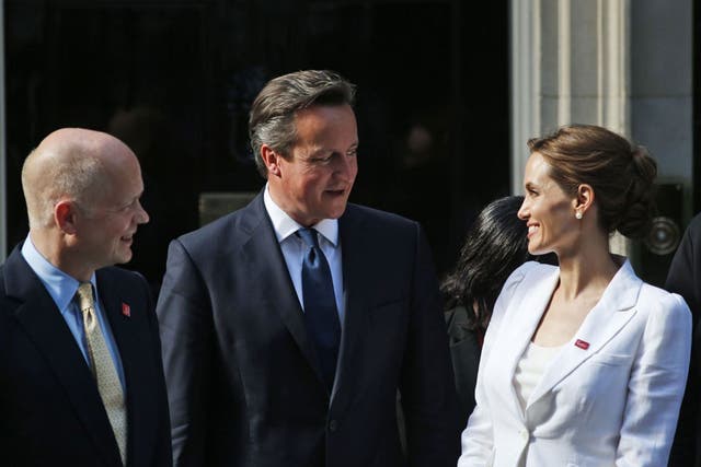 Angelina Jolie talks to David Cameron and William Hague as they pose for the photographers on the doorstep of 10 Downing Street