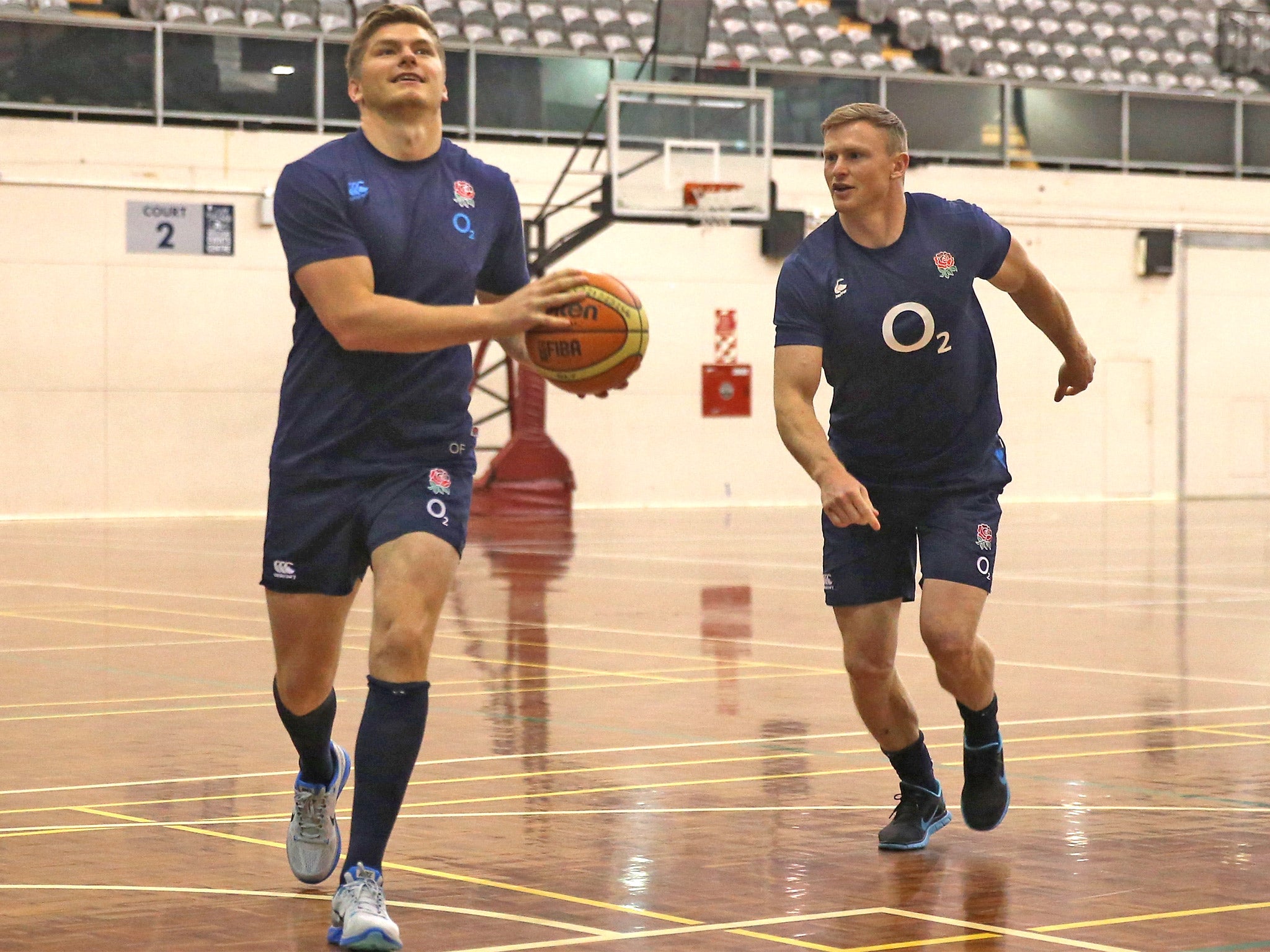 Owen Farrell moves away from Chris Ashton in a basketball warm-up game during an England training session