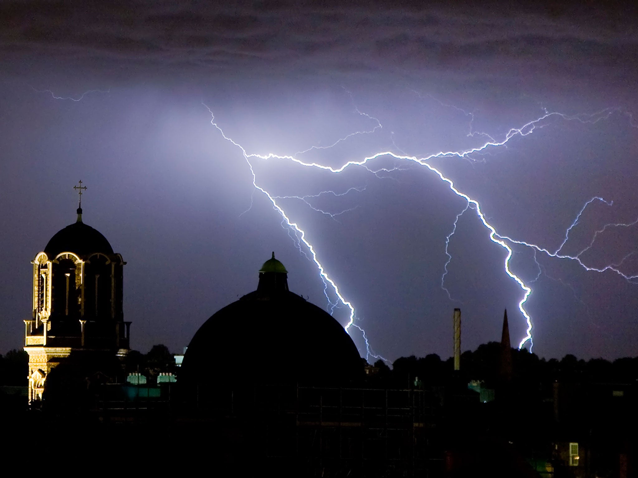 Lightning flashes in the night sky over South London, England