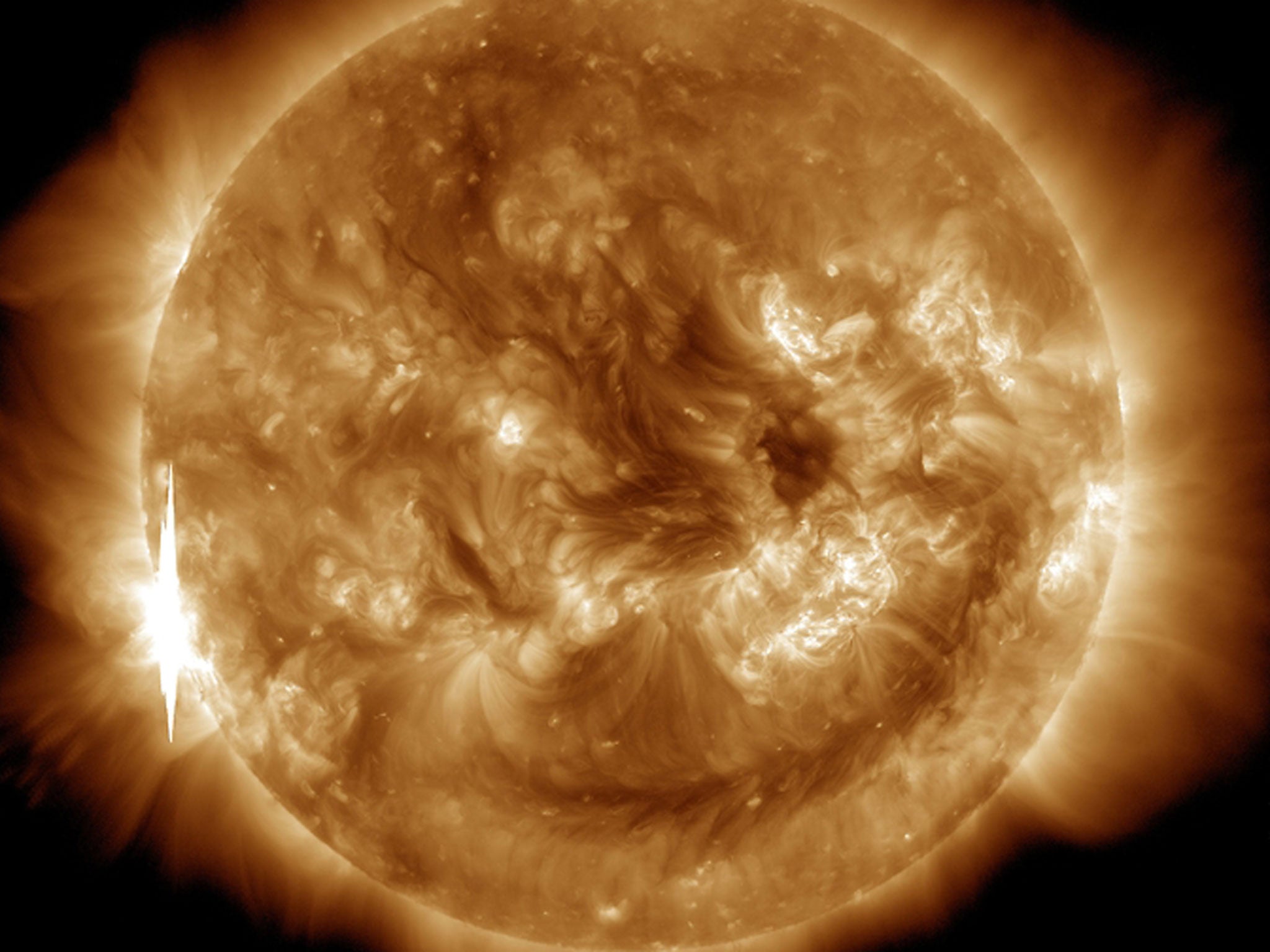 The second X-class flare of June 10, 2014, appears as a bright flash on the left side of this image from NASA’s Solar Dynamics Observatory