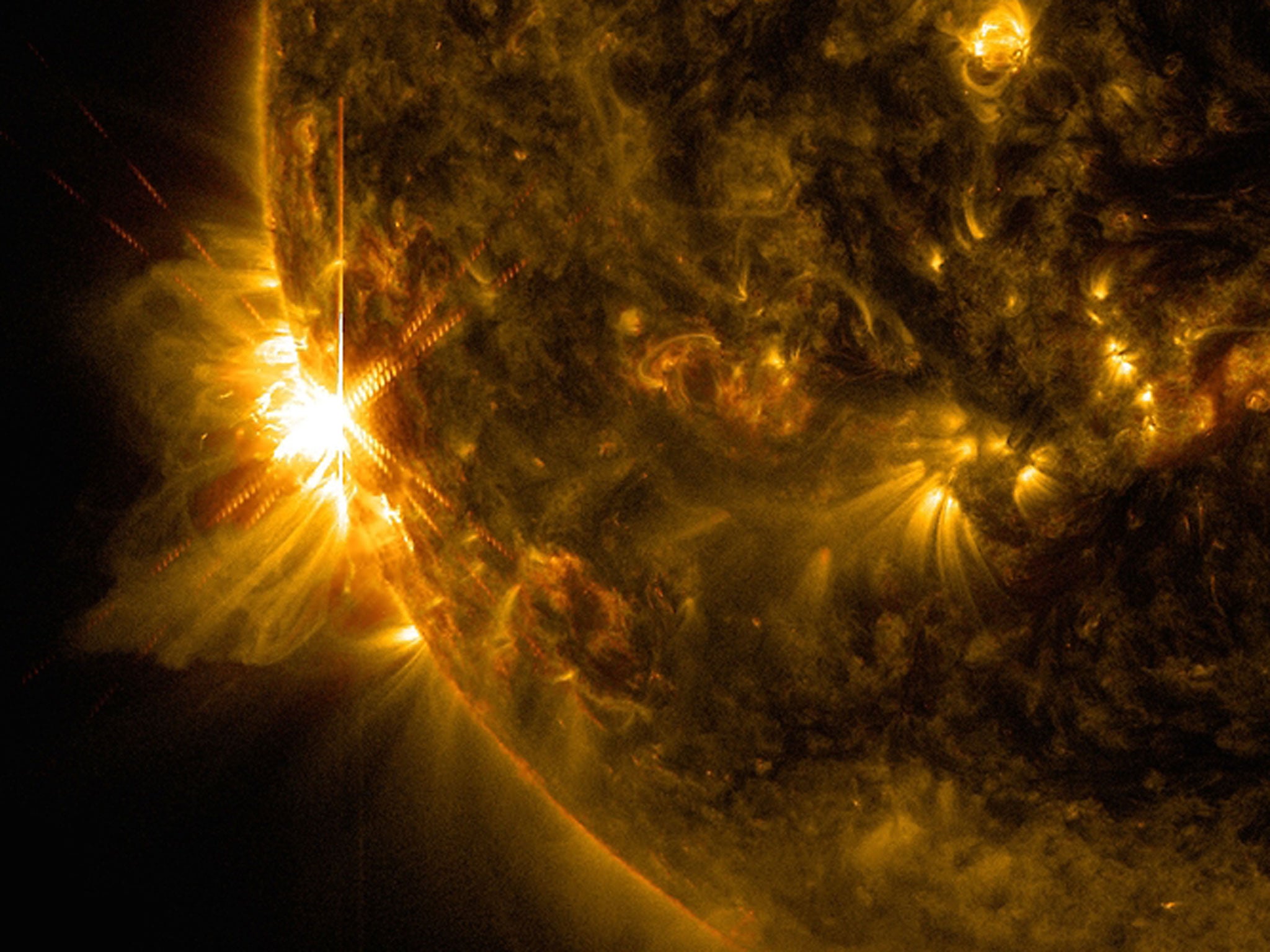 An X2.2 flare solar flare bursts off the left limb of the sun in this image captured by NASA's Solar Dynamics Observatory on June 10, 2014, at 7:41 a.m. EDT.