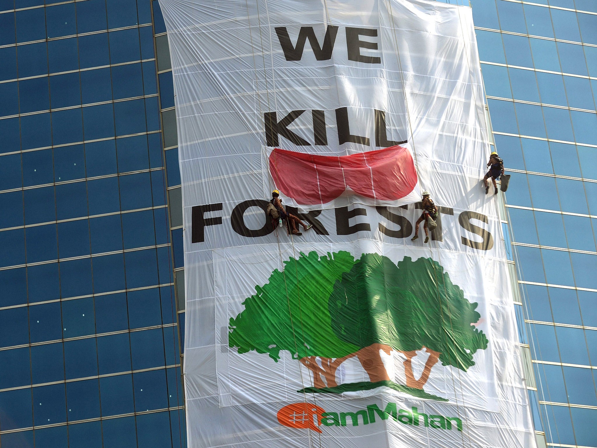 Greenpeace activists drape the headquarters of India's Essar Group with a giant banner during a protest in Mumbai earlier this year