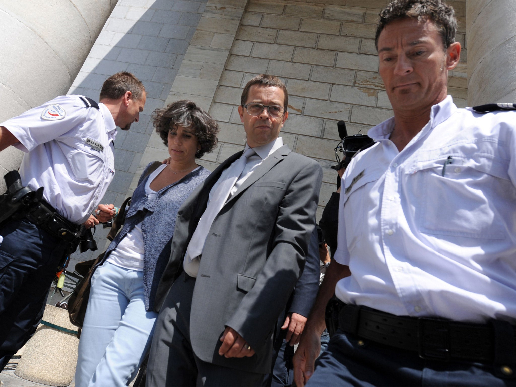 Nicolas Bonnemaison (centre) leaving the Pau courthouse with his wife Julie on the first day of his trial