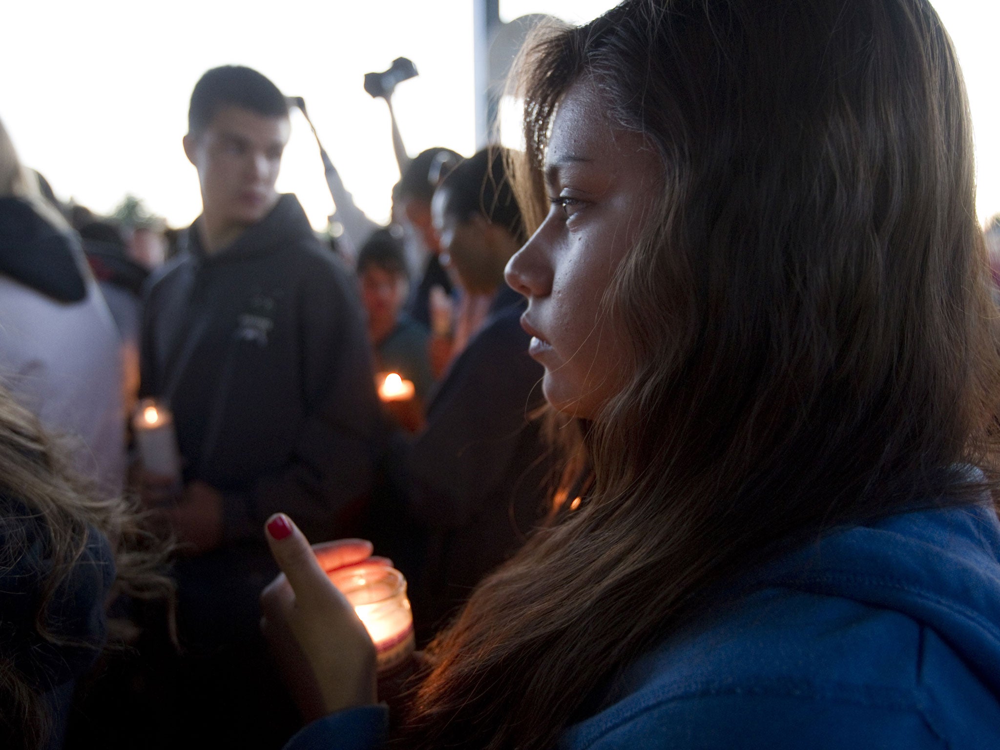 A student holds a candle for Emilio Hoffman the victim of today's school shooting at a vigil on June 10, 2014 in Troutdale, Oregon. A gunman walked into Reynolds High School with a rifle and shot 14 year old Hoffman to death on Tuesday, in what is the the third outbreak of gun violence in a U.S. school in less than three weeks.