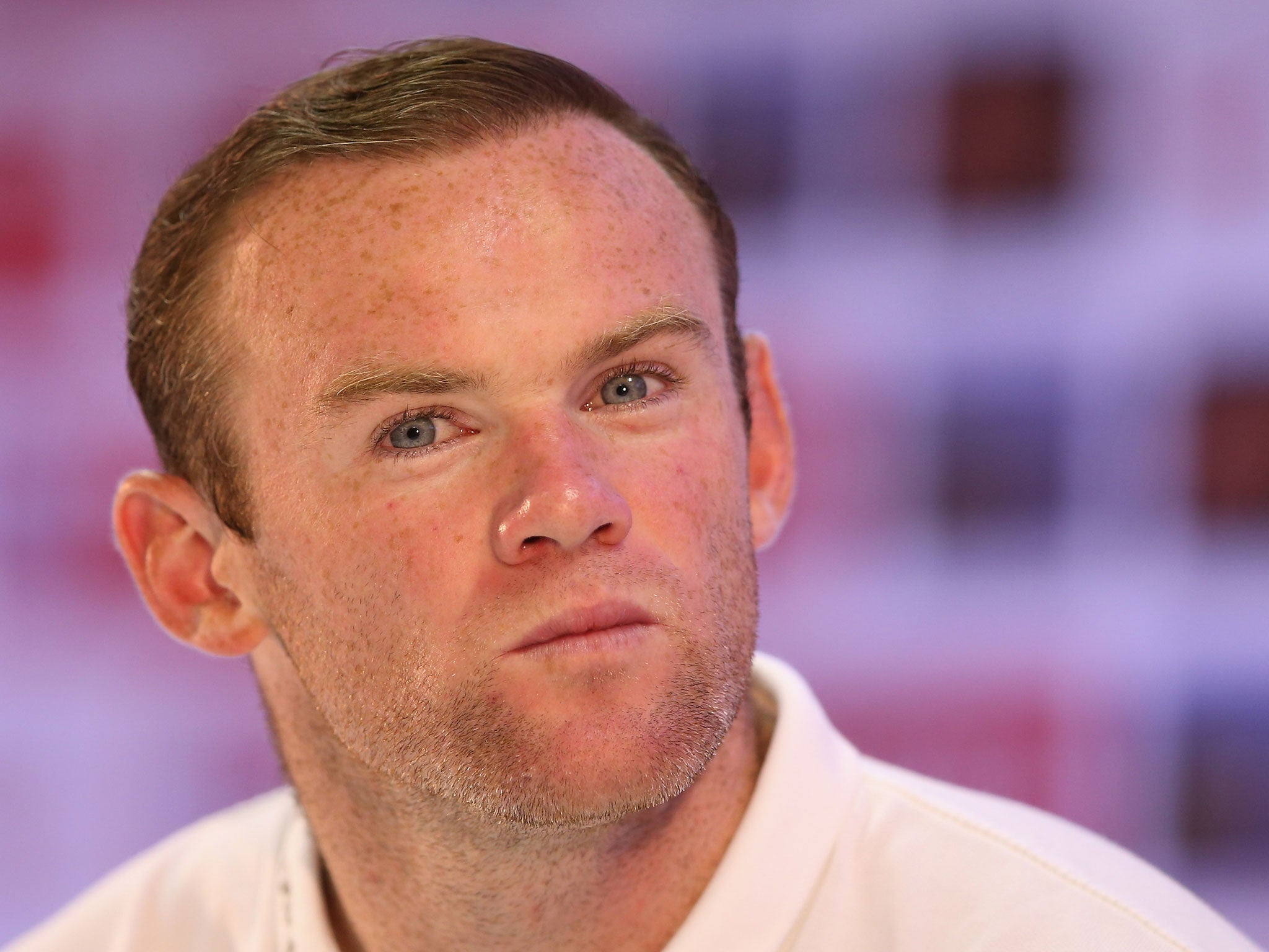 Wayne Rooney talks to the media during a press conference