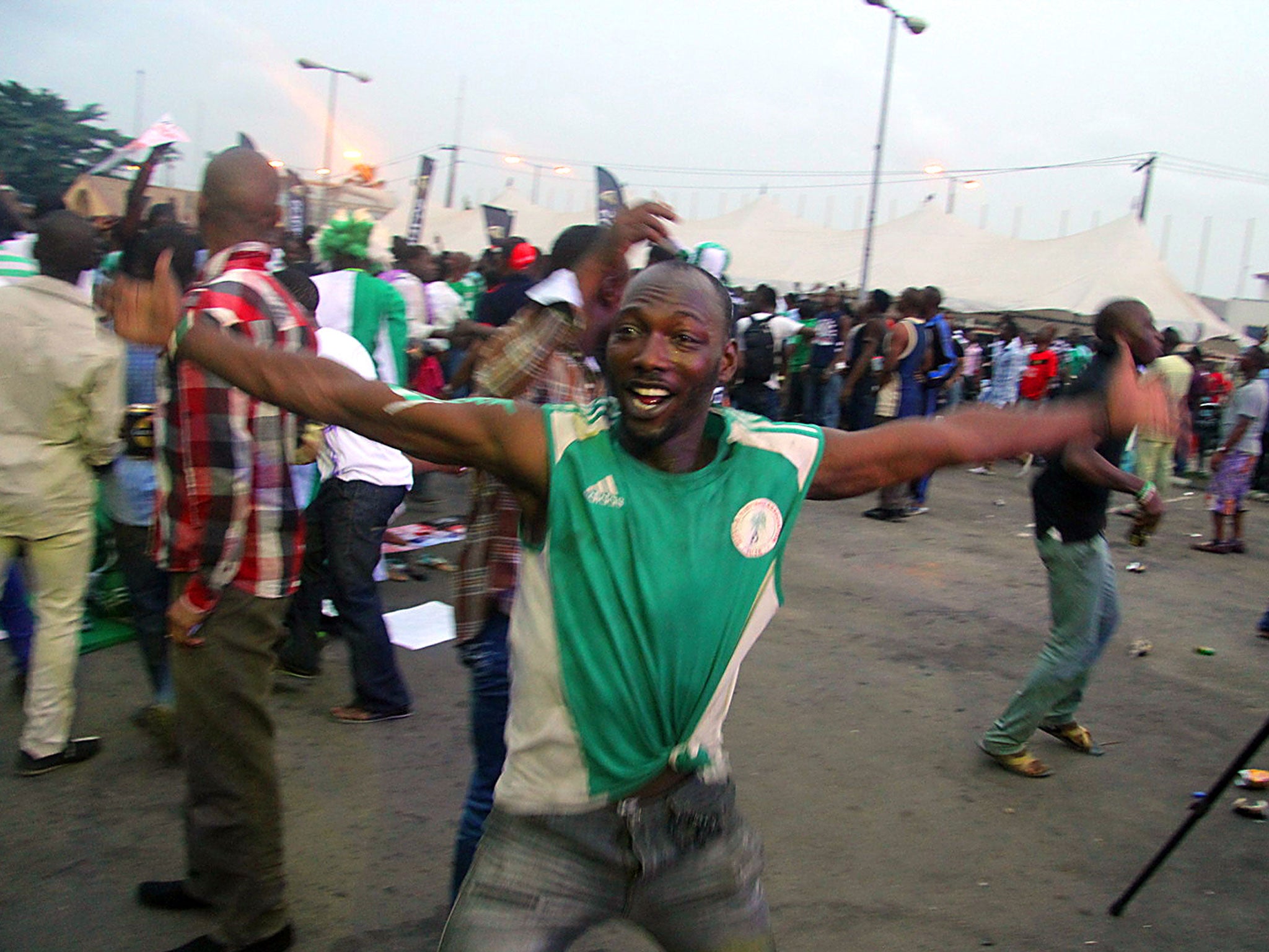 Nigerian fans celebrate at a screening at the Teslim Balogun Stadium in the Surulere area of Lagos ahead of the 2013 African Cup of Nations final football match between Nigeria and Burkina Faso