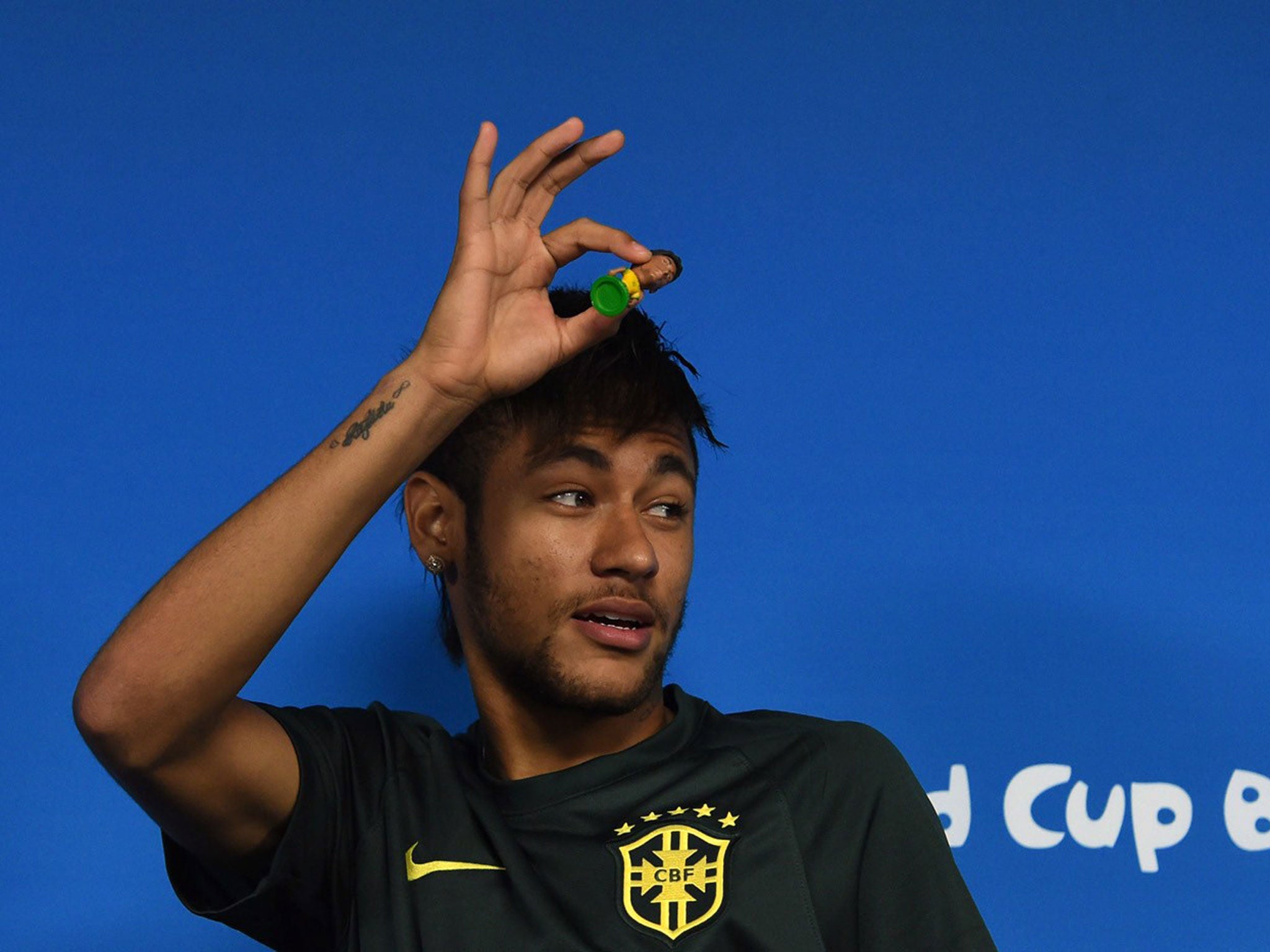 Brazil's forward Neymar looks at journalists during a press conference in Sao Paulo