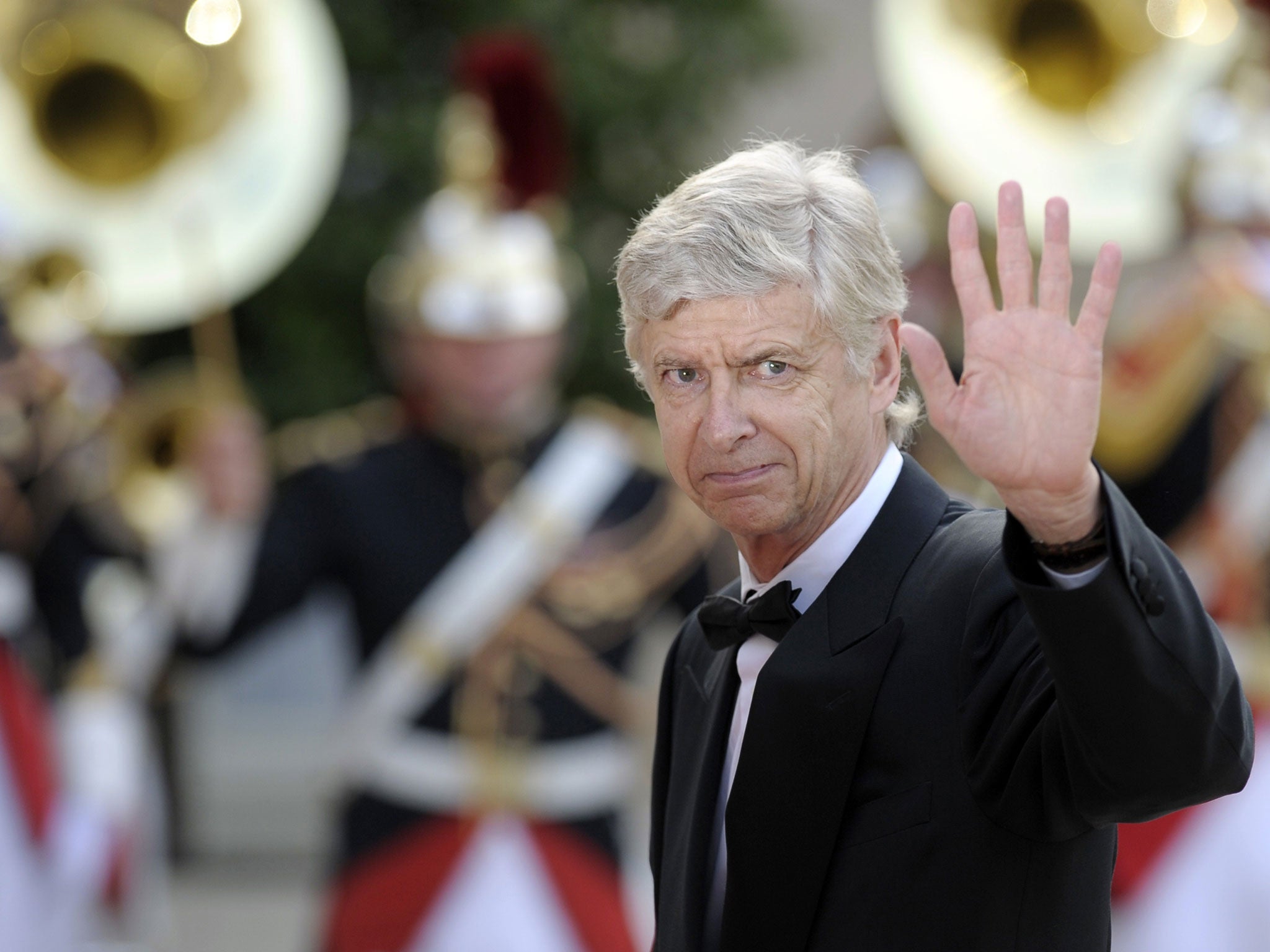 Arsenal's French coach Arsene Wenger waves as he arrive for a state dinner at the Elysee presidential palace in Paris