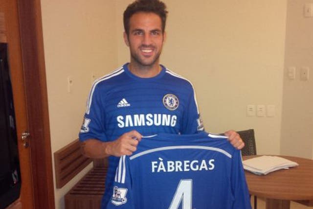 Cesc Fabregas poses with his Chelsea shirt after signing 