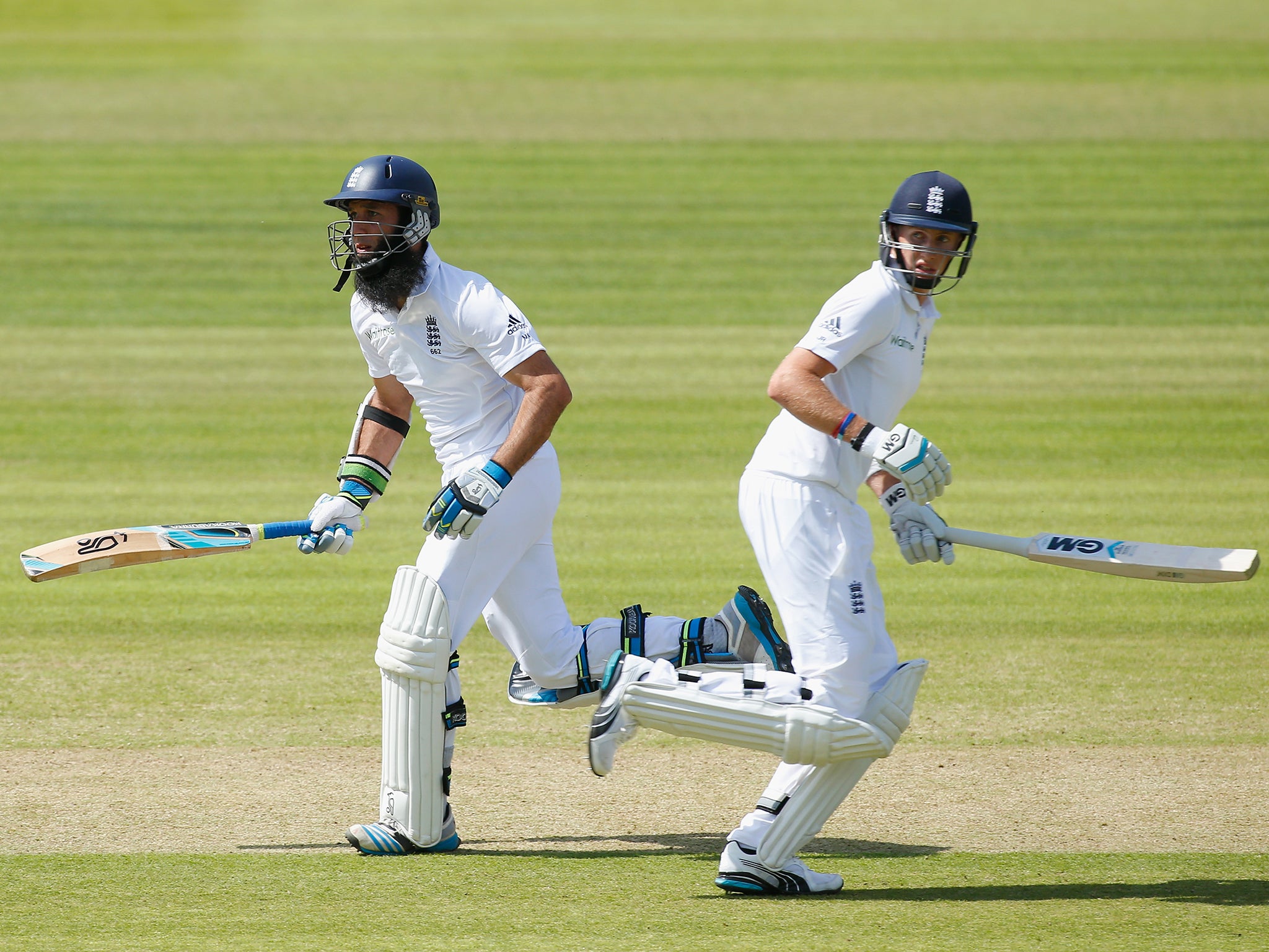 Moeen Ali (L) and Joe Root of England run between the wickets during day one of the 1st Investec Test match between England and Sri Lanka at Lord's