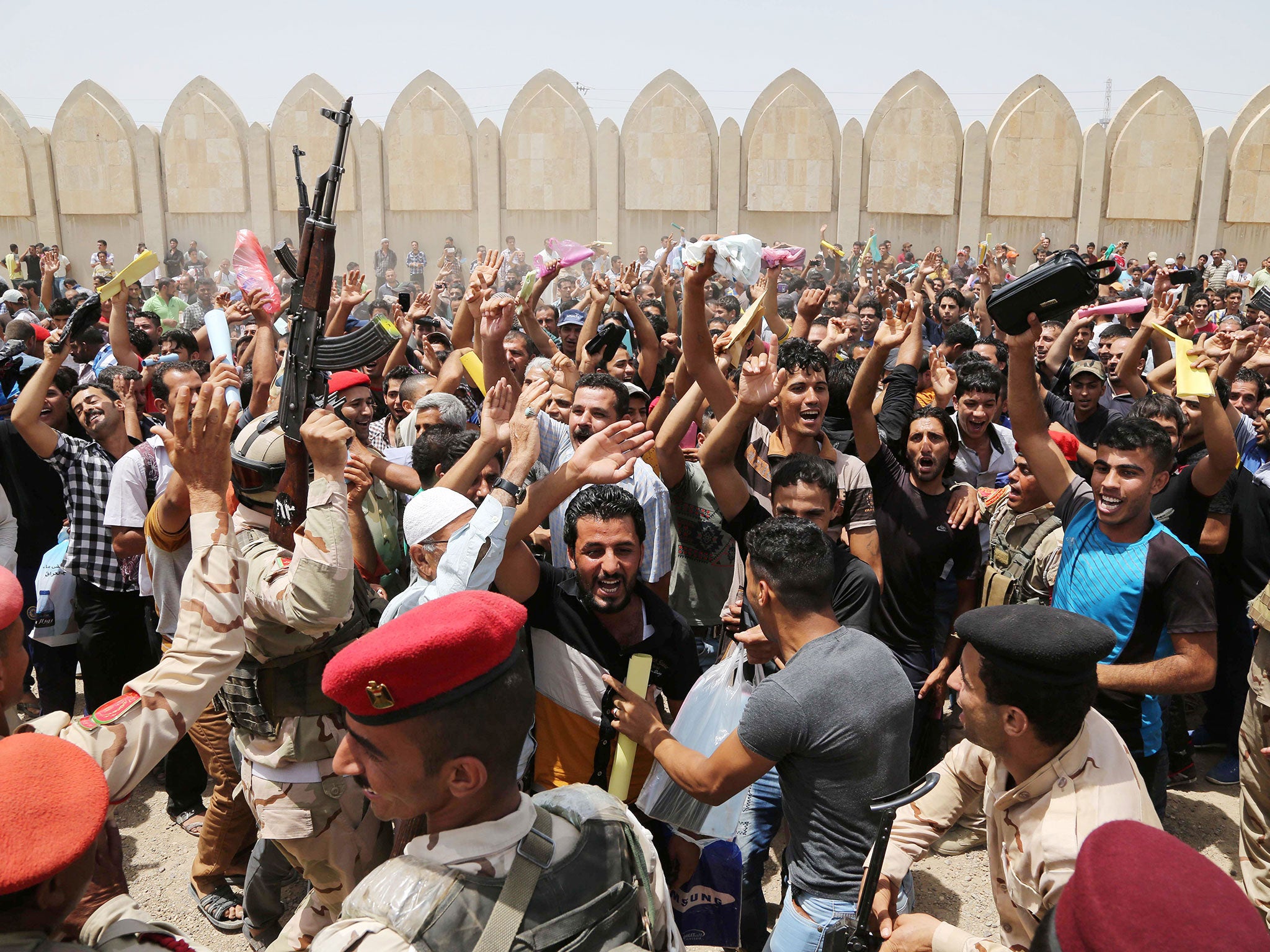 Young men in Baghdad chant slogans against Isis outside the main army recruiting
centre yesterday, where they are volunteering to fight the extremist group
