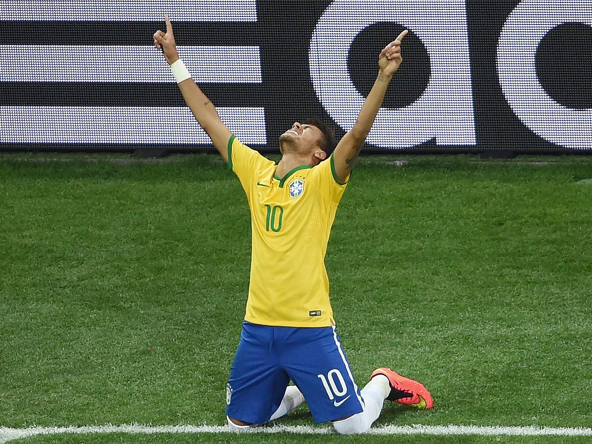 Brazil's forward Neymar celebrates after scoring a penalty during a Group A football match between Brazil and Croatia at the Corinthians Arena in Sao Paulo