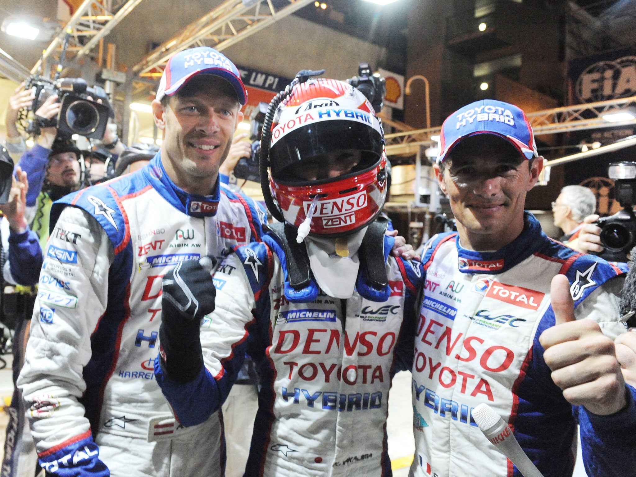 Japanese Kazuki Nakajima (Toyota TS 040 Hybrid N° 7) is congratulated by his Teammates Austrian Alexander Wurz and French Stephane Sarrazin (L to R)