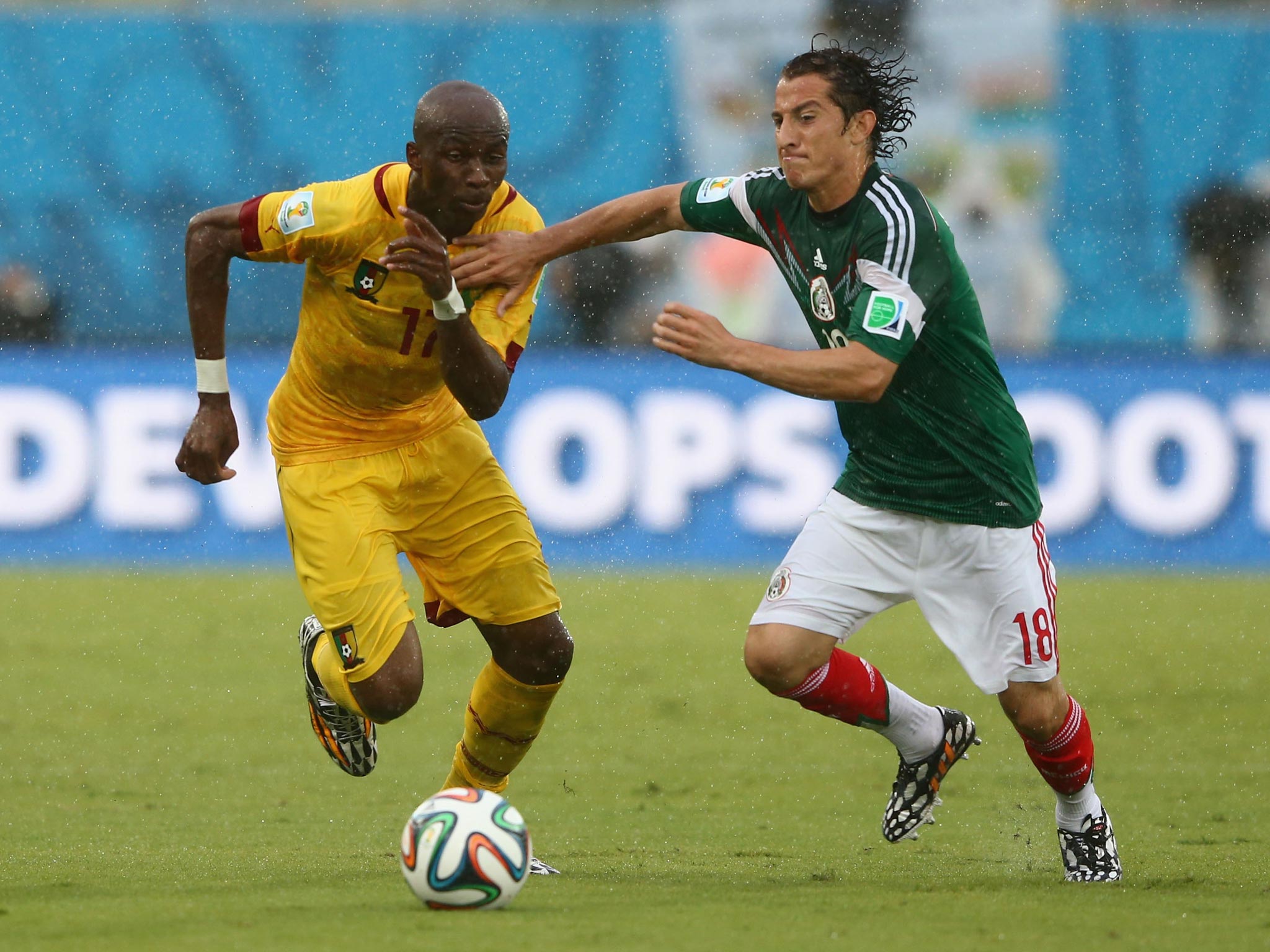 Andres Guardado of Mexico challenges Stephane Mbia of Cameroon