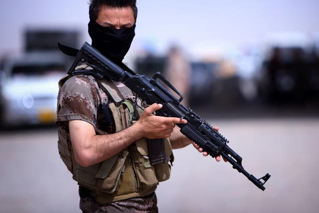 A masked Pershmerga fighter from Iraq's autonomous Kurdish region