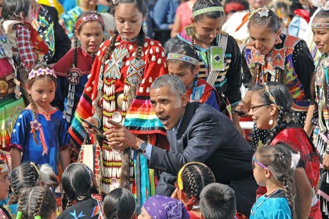 Obama greets tribal children during the visit to the reservation in Cannon Ball