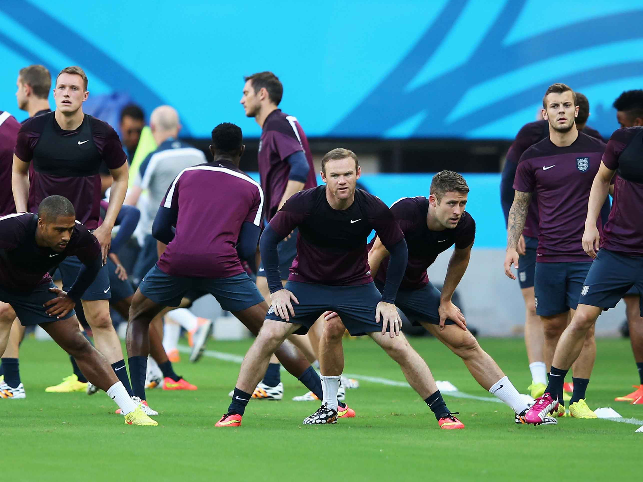 Wayne Rooney stretches with team mates during the England training session ahead of their first match of the 2014 World Cup Brazil against Italy at Arena Amazonia in Manaus, Brazil.