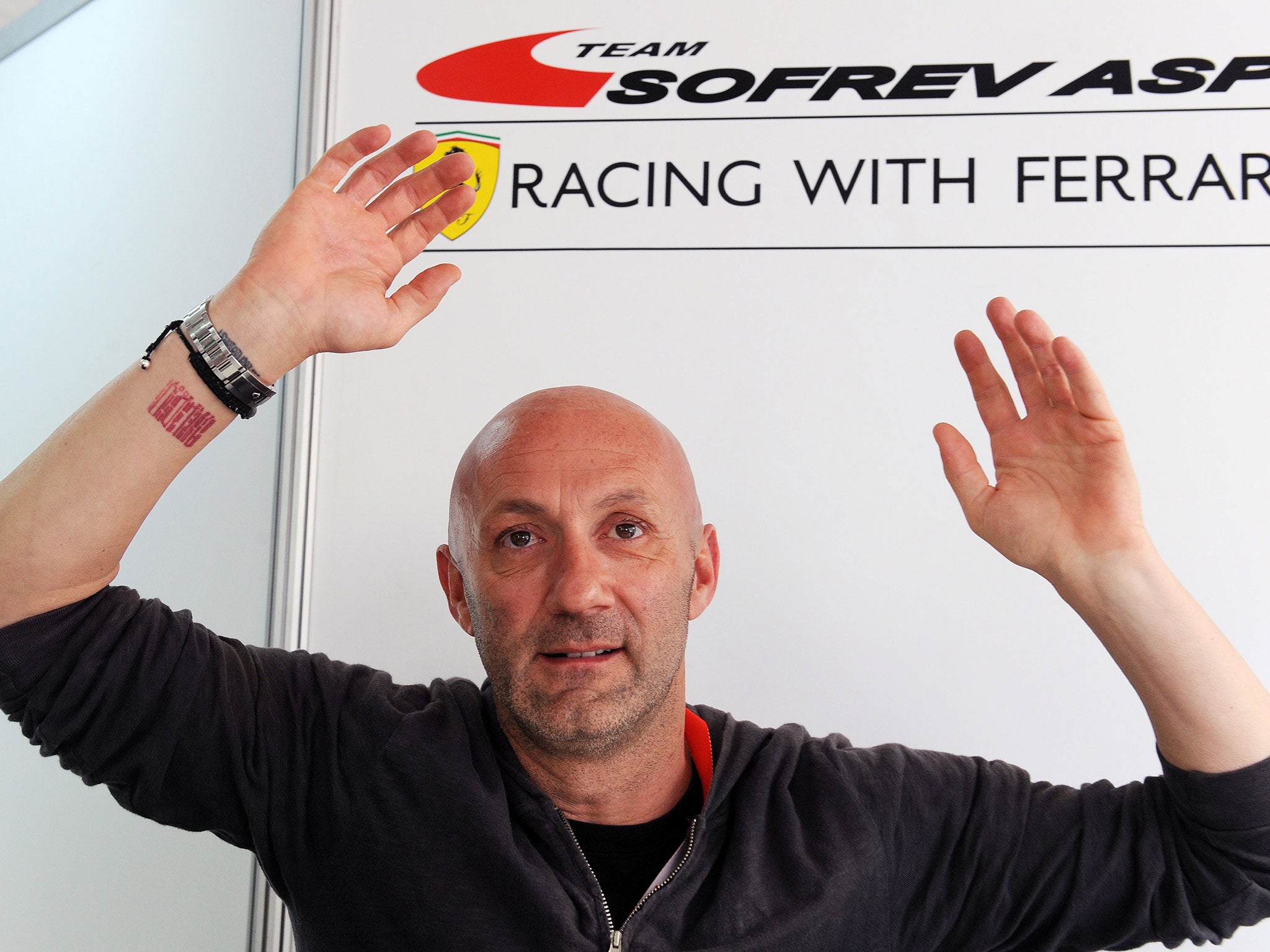 France's soccer team former goalkeeper and 1998 World Cup winner Fabien Barthez, driving the Ferrari 458 Italia N°58, speaks during a press conference on June 13, 2014 in Le Mans