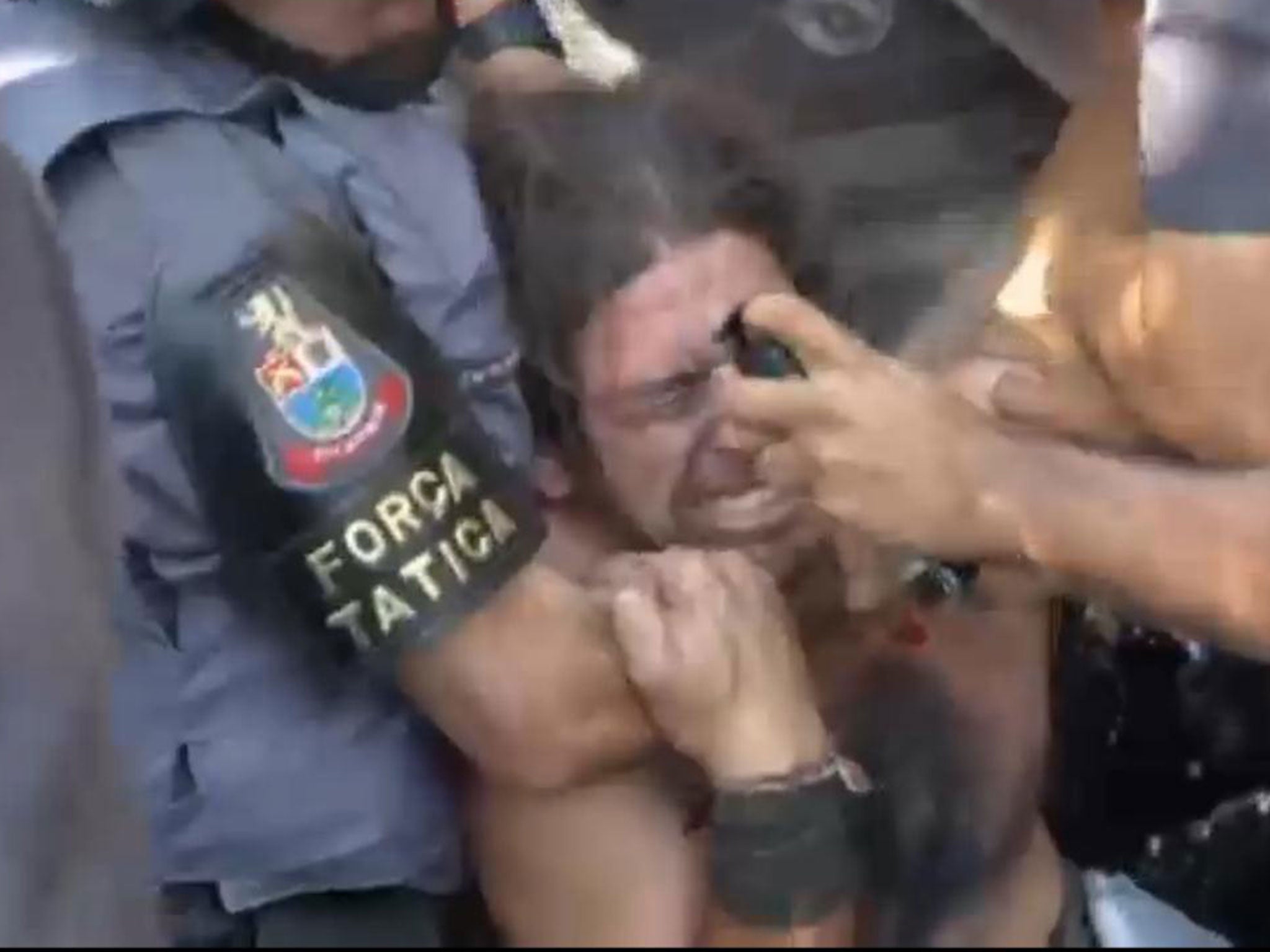 Shocking video footage has emerged showing an anti-World Cup protester as he is sprayed in the eyes by riot police with pepper spray at point blank range.
